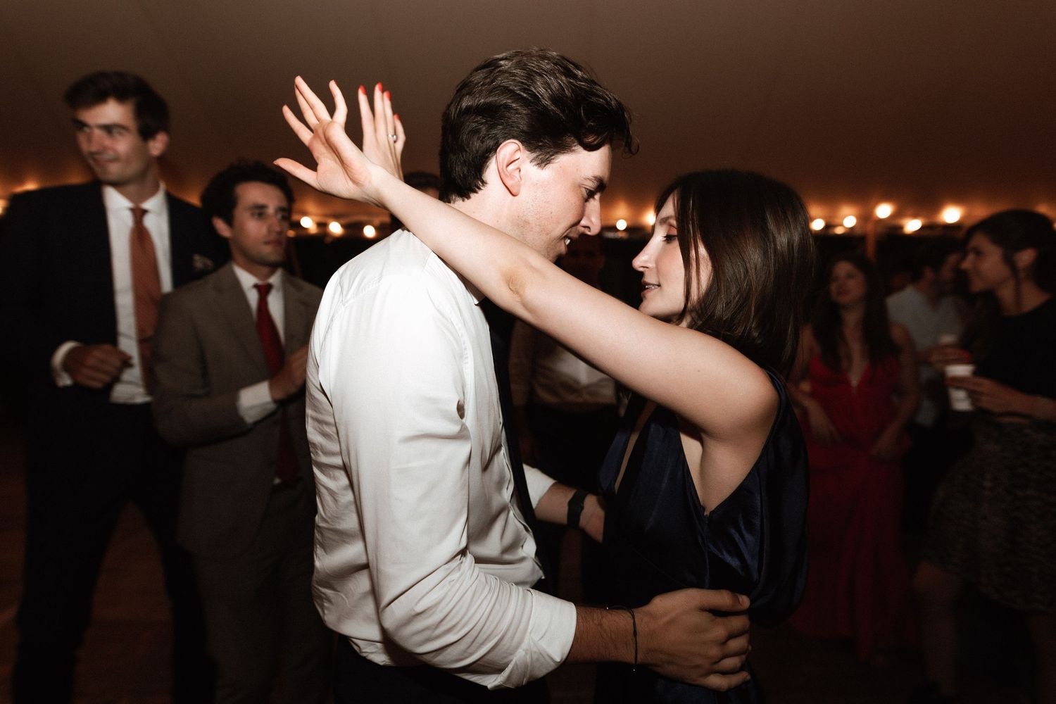 A couple shares a romantic dance moment at their wedding celebration.