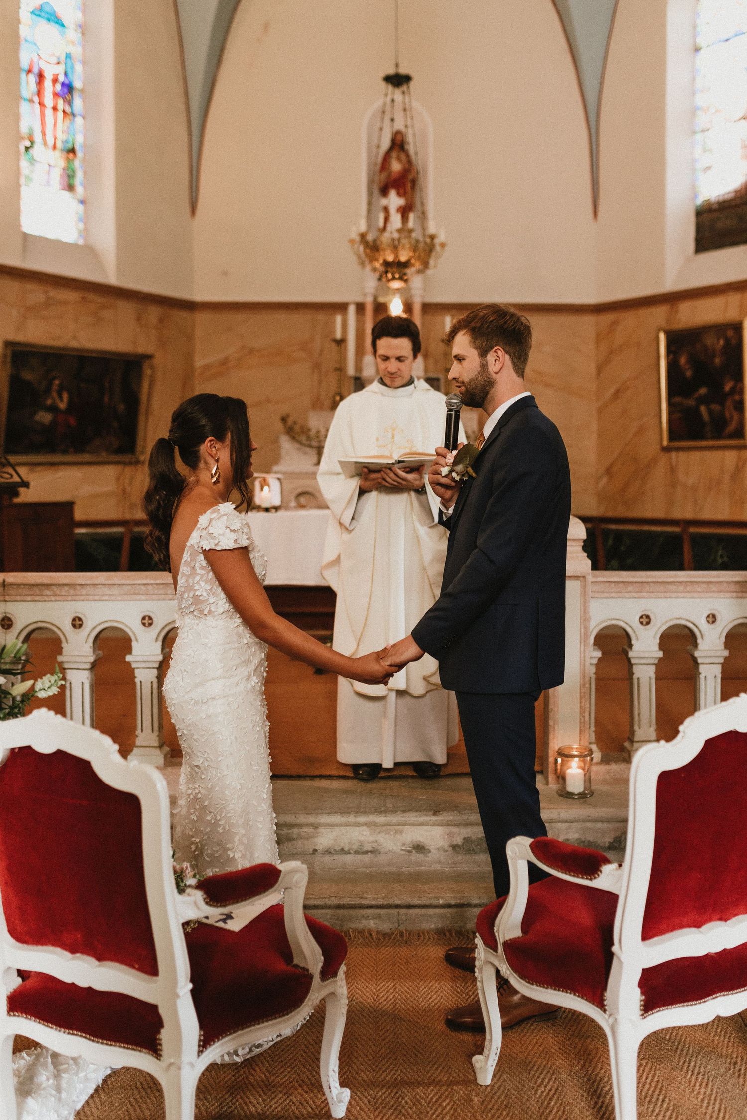 Traditional church wedding ceremony with ornate architectural details and stained glass windows.