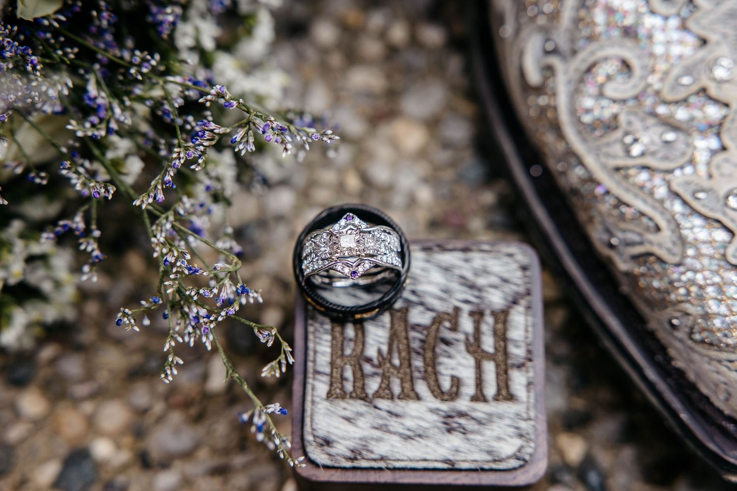 Multiple silver vintage Christmas ornaments with cursive writing decorations displayed in an artful arrangement.