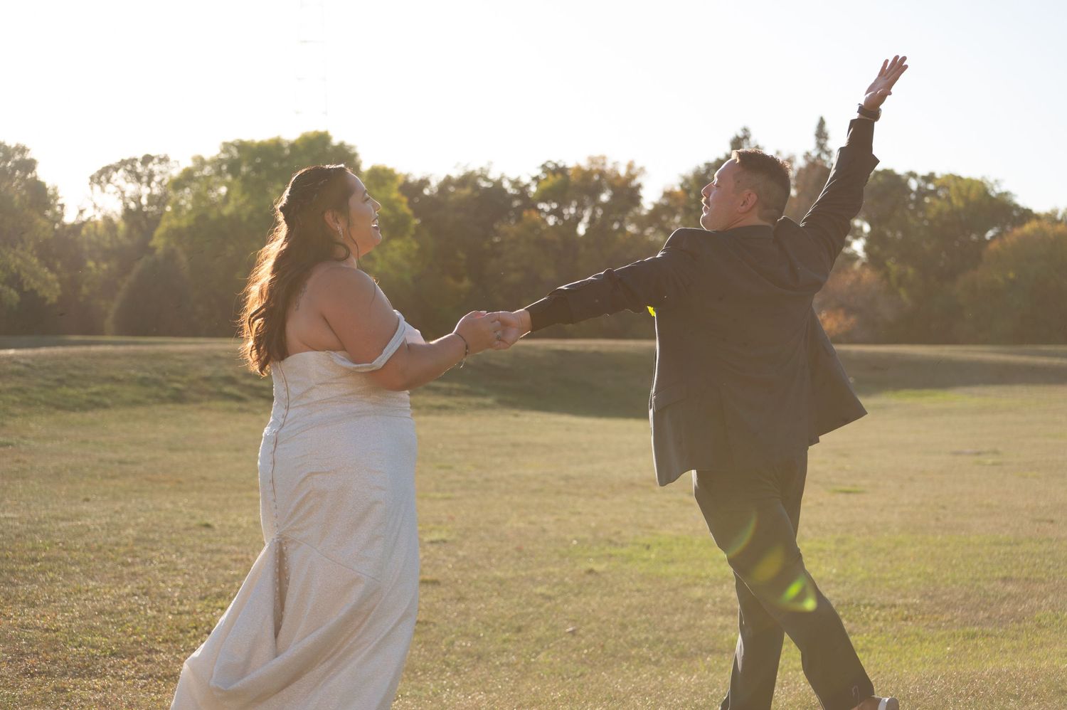 Sunset wedding couple photos with silhouettes dancing in golden light.