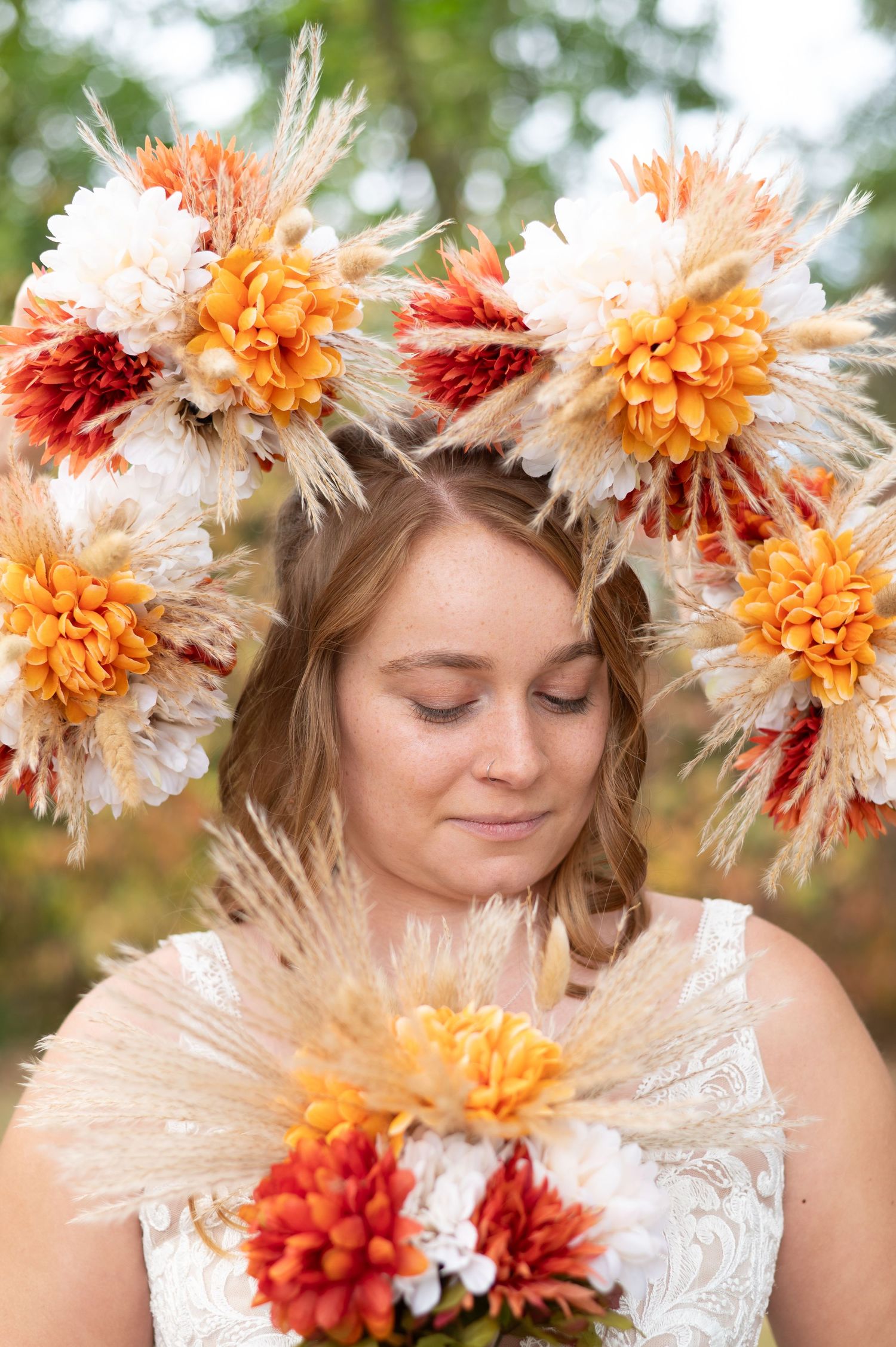 Portrait with autumn-colored floral crown featuring orange and cream dahlias.