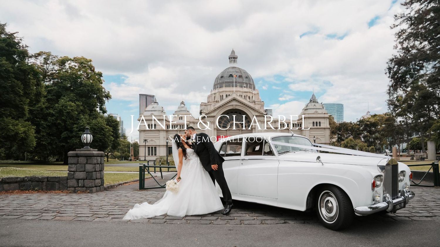 Elegant white vintage car parked outside grand domed architecture.