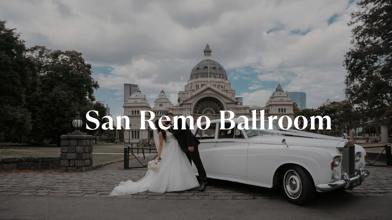 Wedding scene at San Remo Ballroom with classic white vintage car and domed building in background.