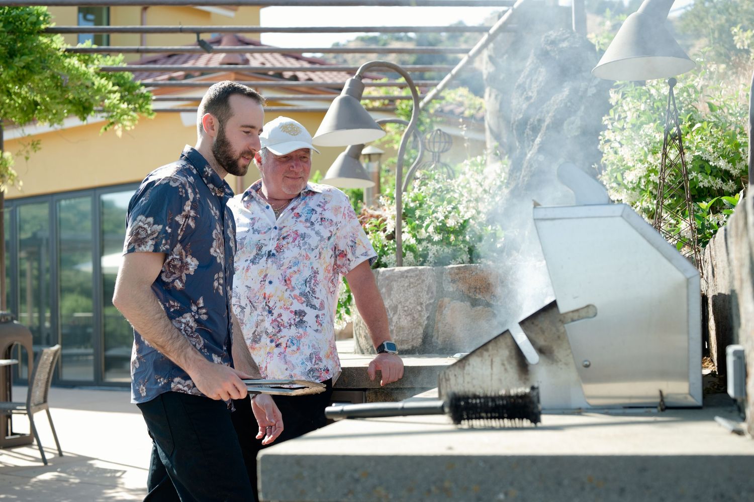 A father and son grill together at Patland Estate Winery, enjoying an outdoor cooking scene in the scenic Soda Canyon hills of Napa Valley.
