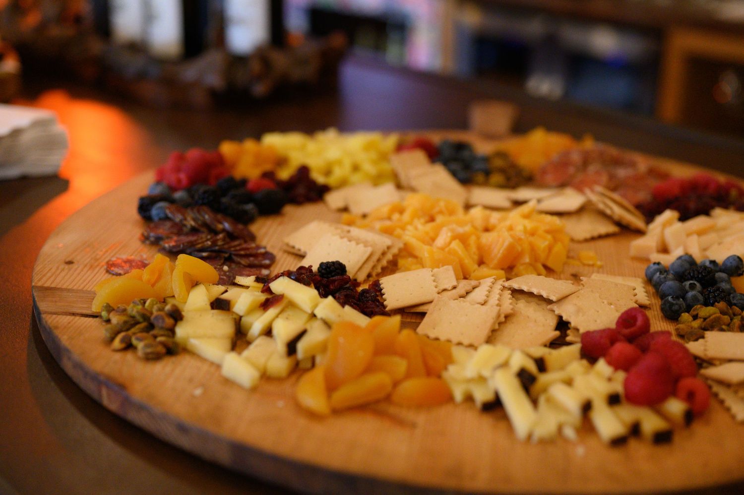 A beautifully arranged charcuterie board with colorful cheeses, meats, and fruits, served at Amapola Creek Tasting Room in Sonoma.