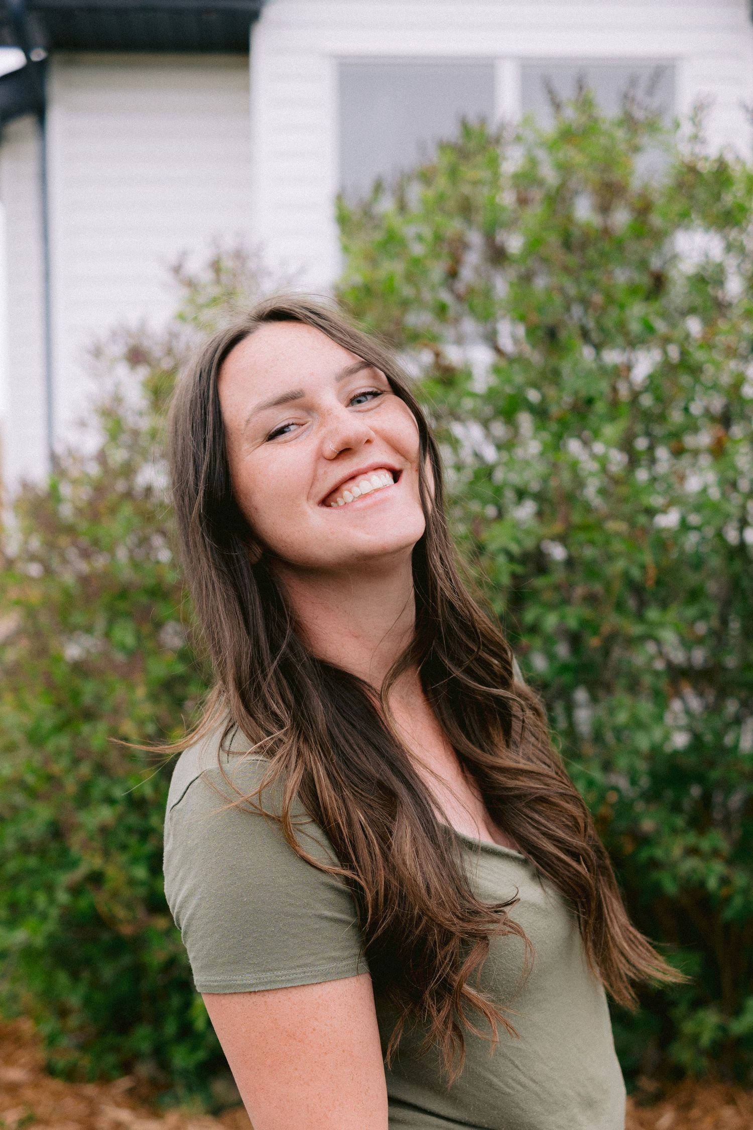 Series of candid portraits showing a woman with long brown hair laughing joyfully.