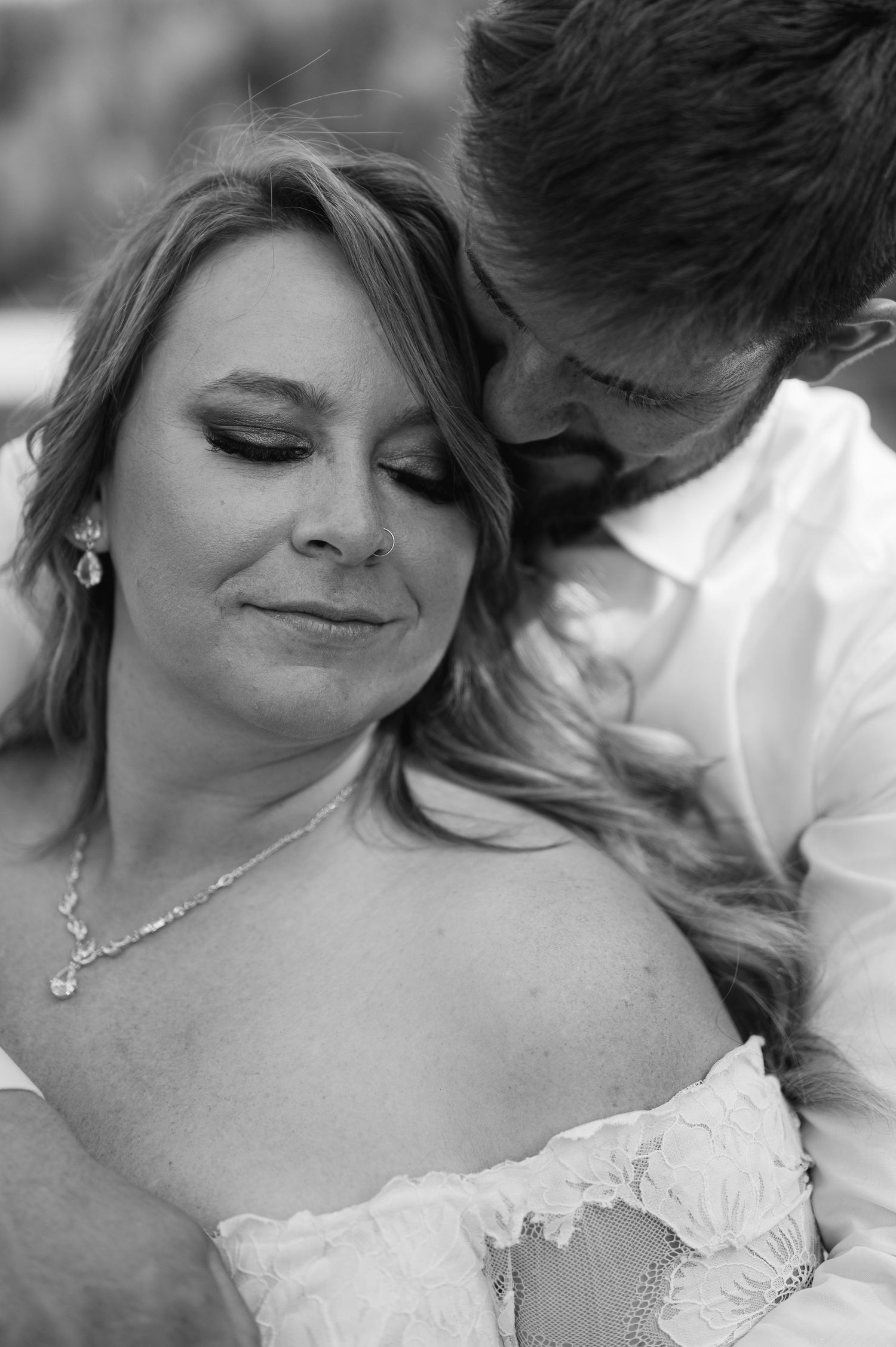 Intimate black and white close-up portraits of a couple sharing a romantic moment.