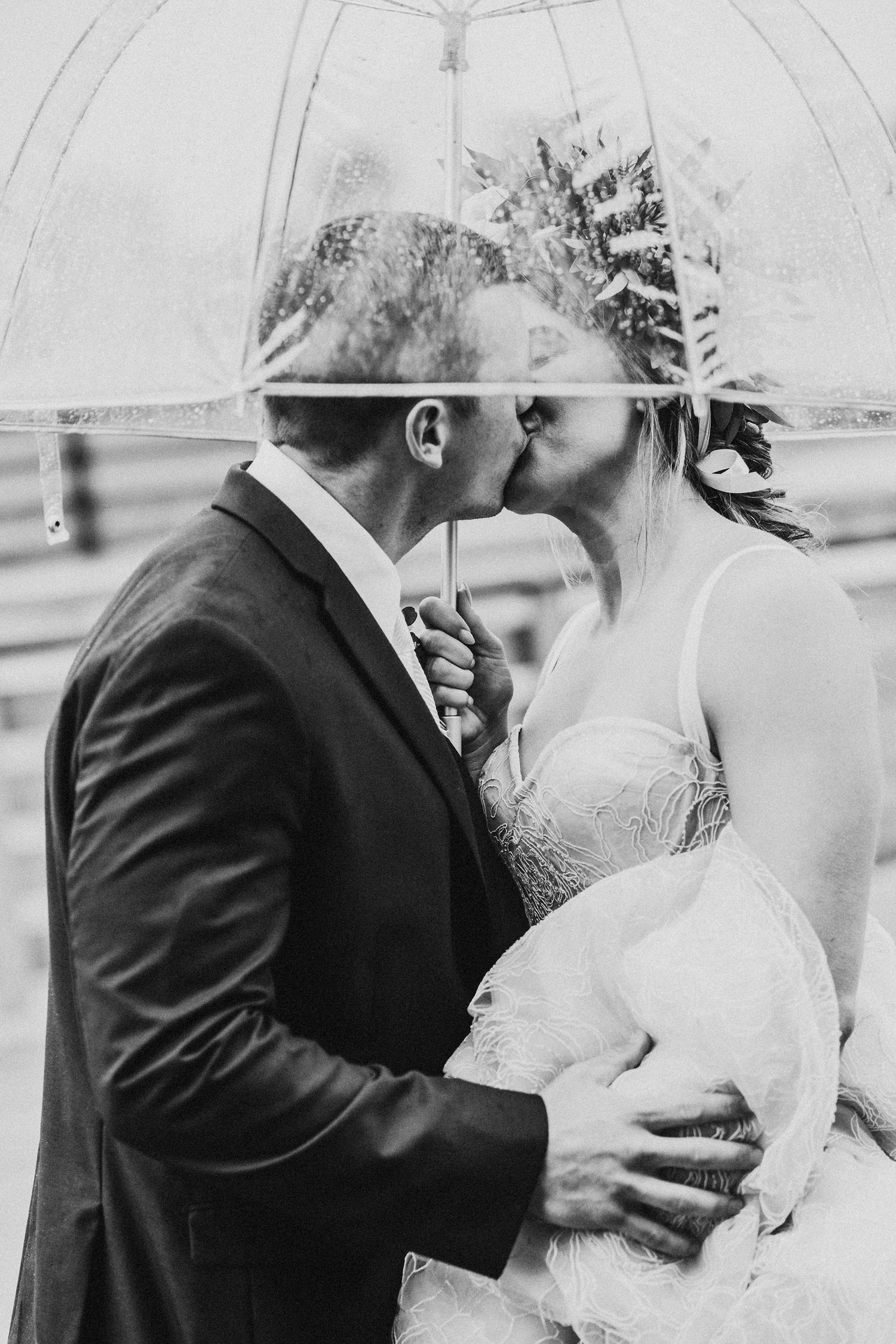 A black and white series of artistic wedding photos showing a couple sharing intimate moments and kisses.