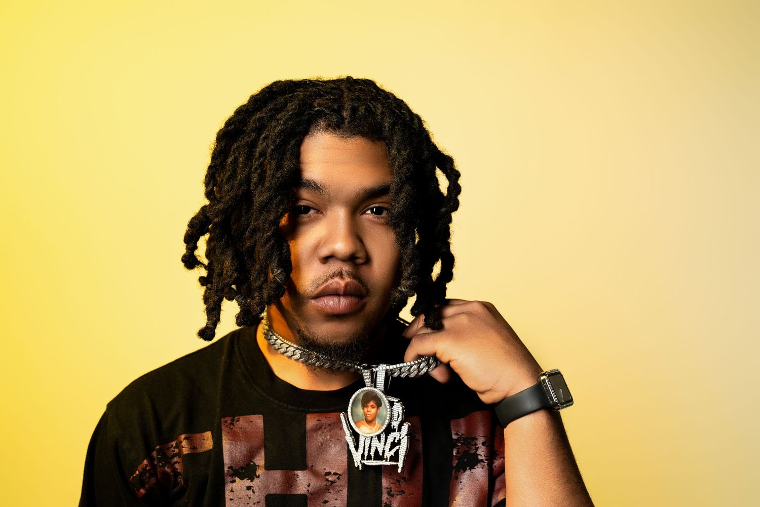 Portrait series against yellow background with dreadlocks and casual style.