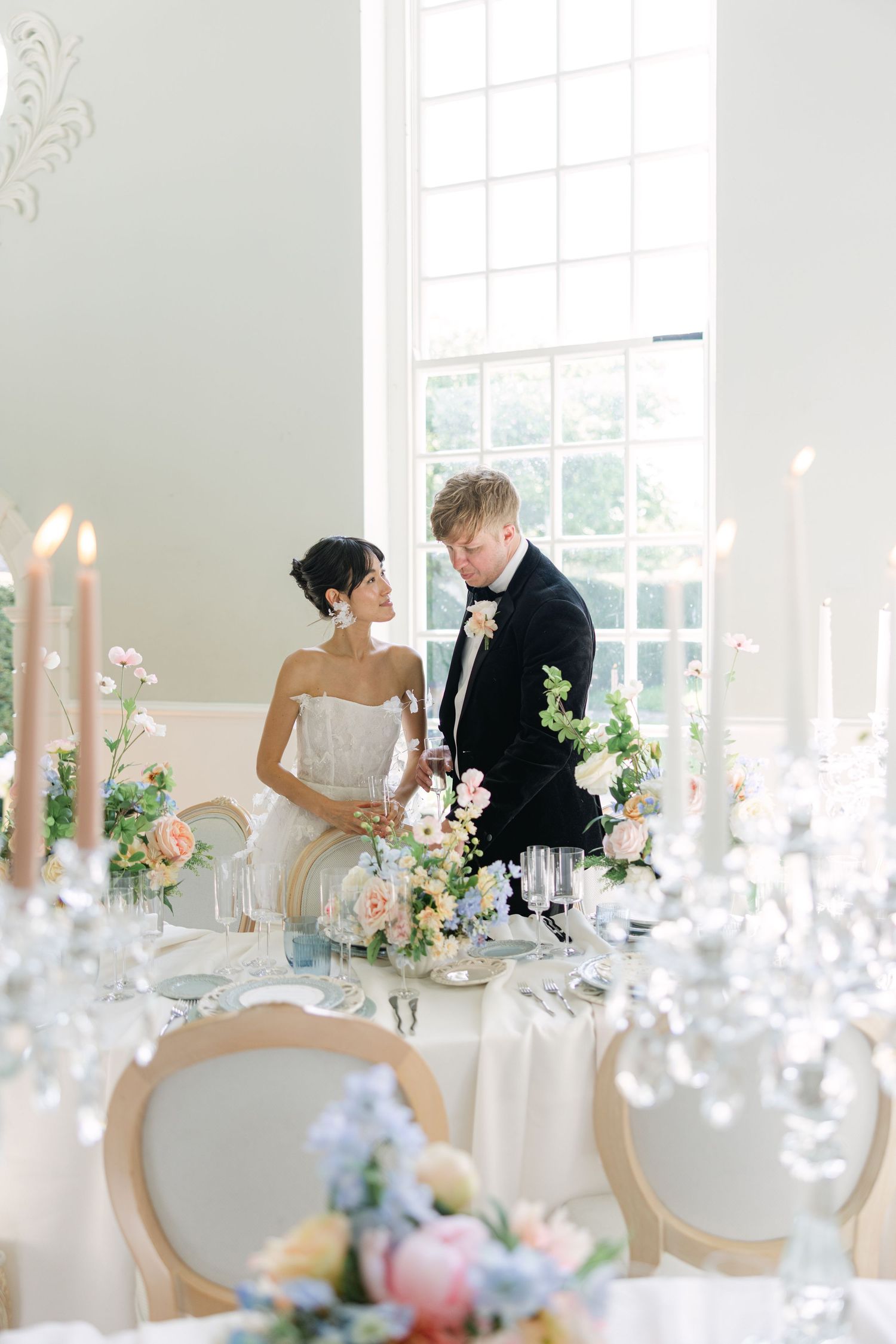 Bride and Groom looking over their reception tablescape during their wedding reception at Cornwell Manor