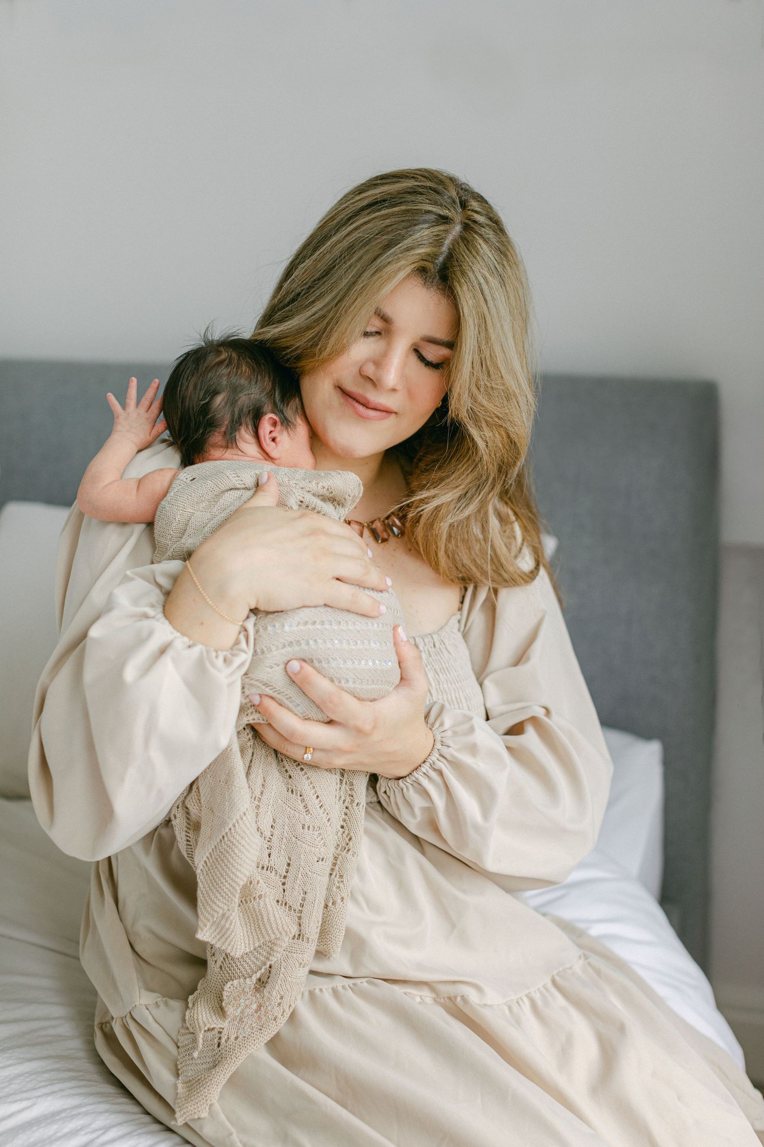 Mother hugging her newborn baby