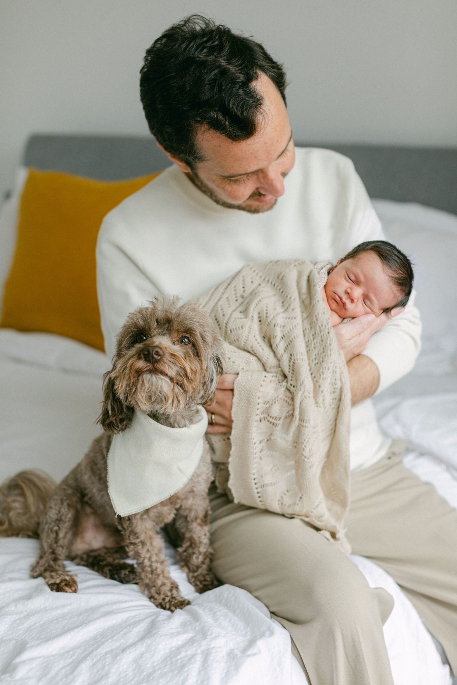 Father and god cuddeling newborn