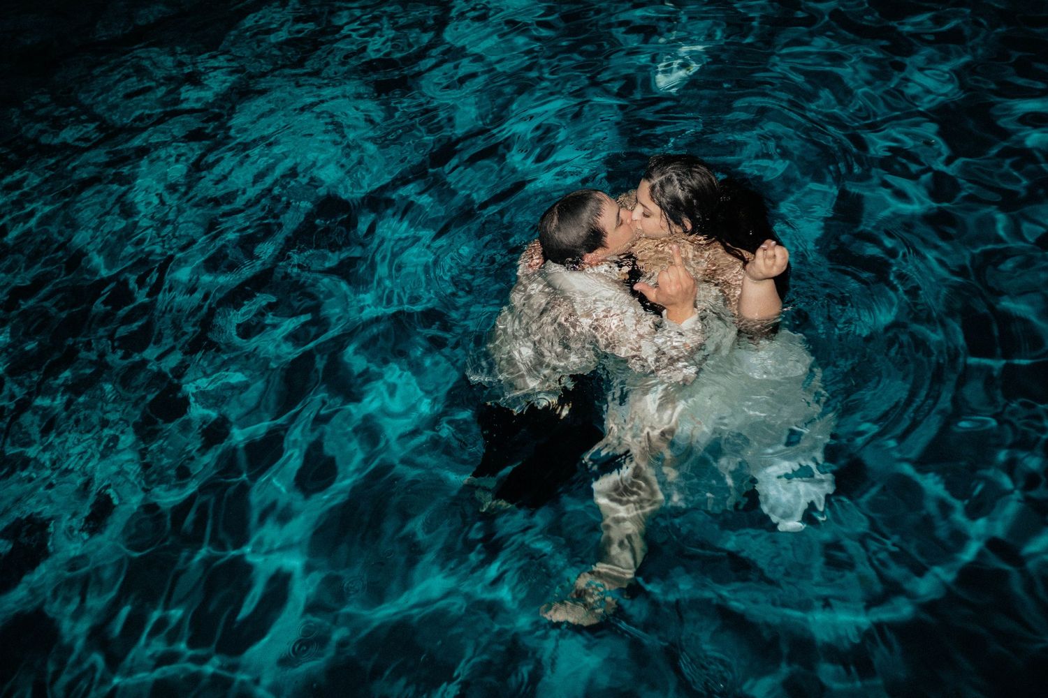 Wedding couples portraits at The Orchard Wedding Venue in Azle, TX in a swimming pool taken by Kaitlyn Fleming Photography