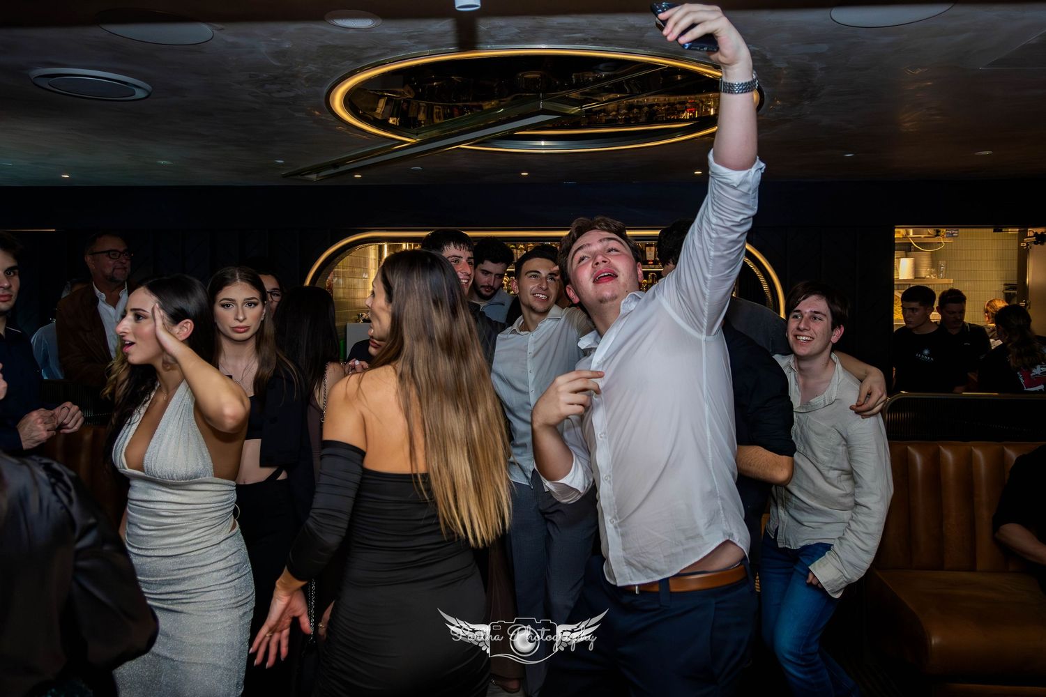 People dancing and celebrating at a lively indoor party venue.
