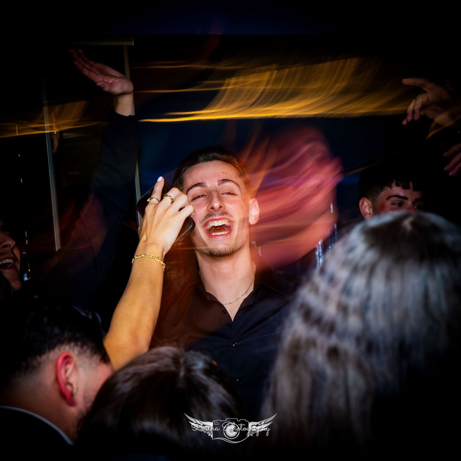 Dynamic nightclub scene with partygoers enjoying the atmosphere under colorful lights.