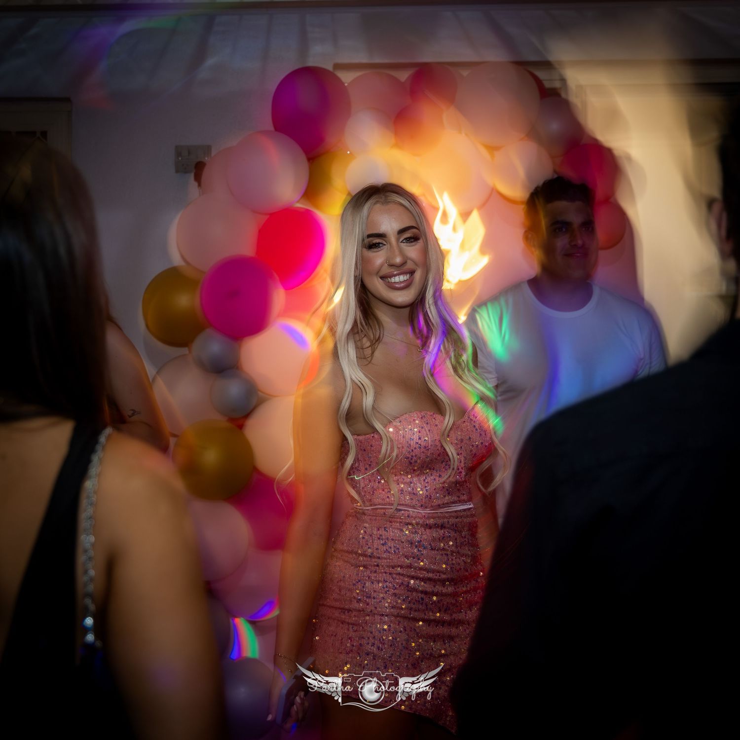 Celebration scene with colorful balloon arrangements and party lighting.