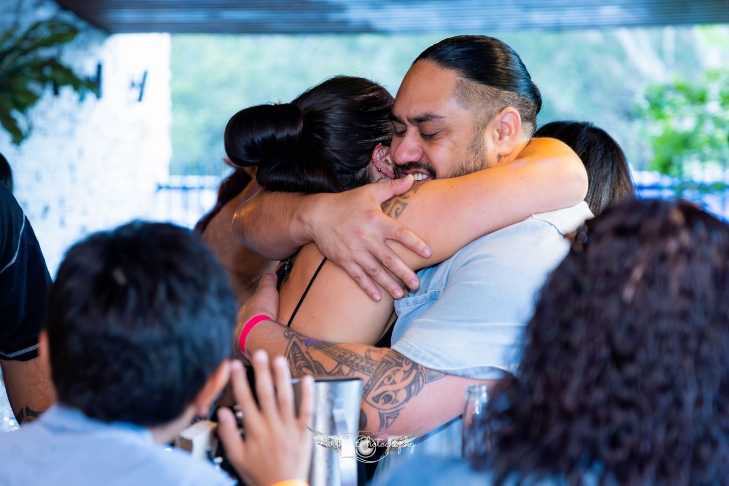Emotional moment shared between party guests during celebration outdoors.