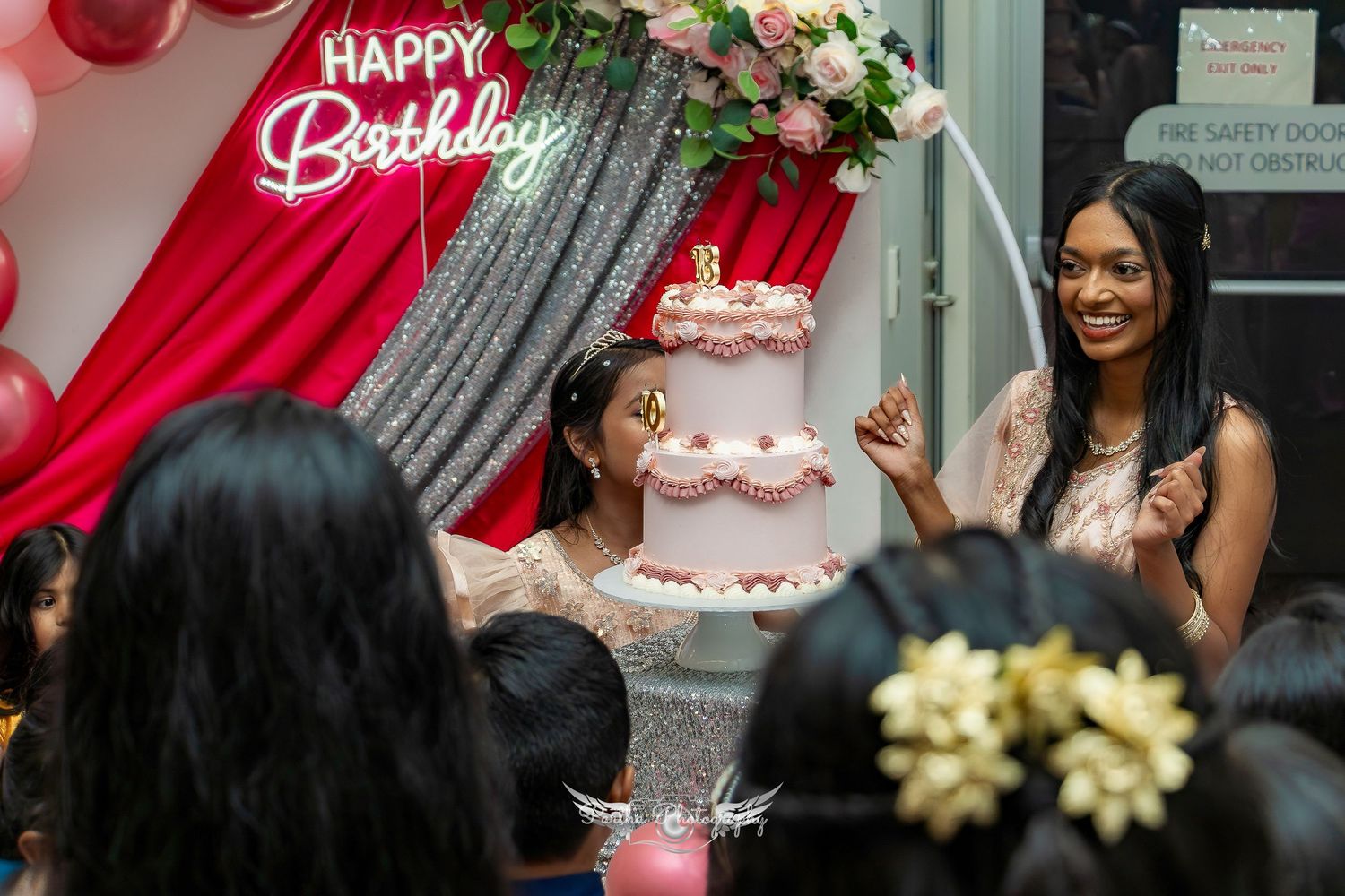 Birthday celebration scene with colorful decorations and cake.