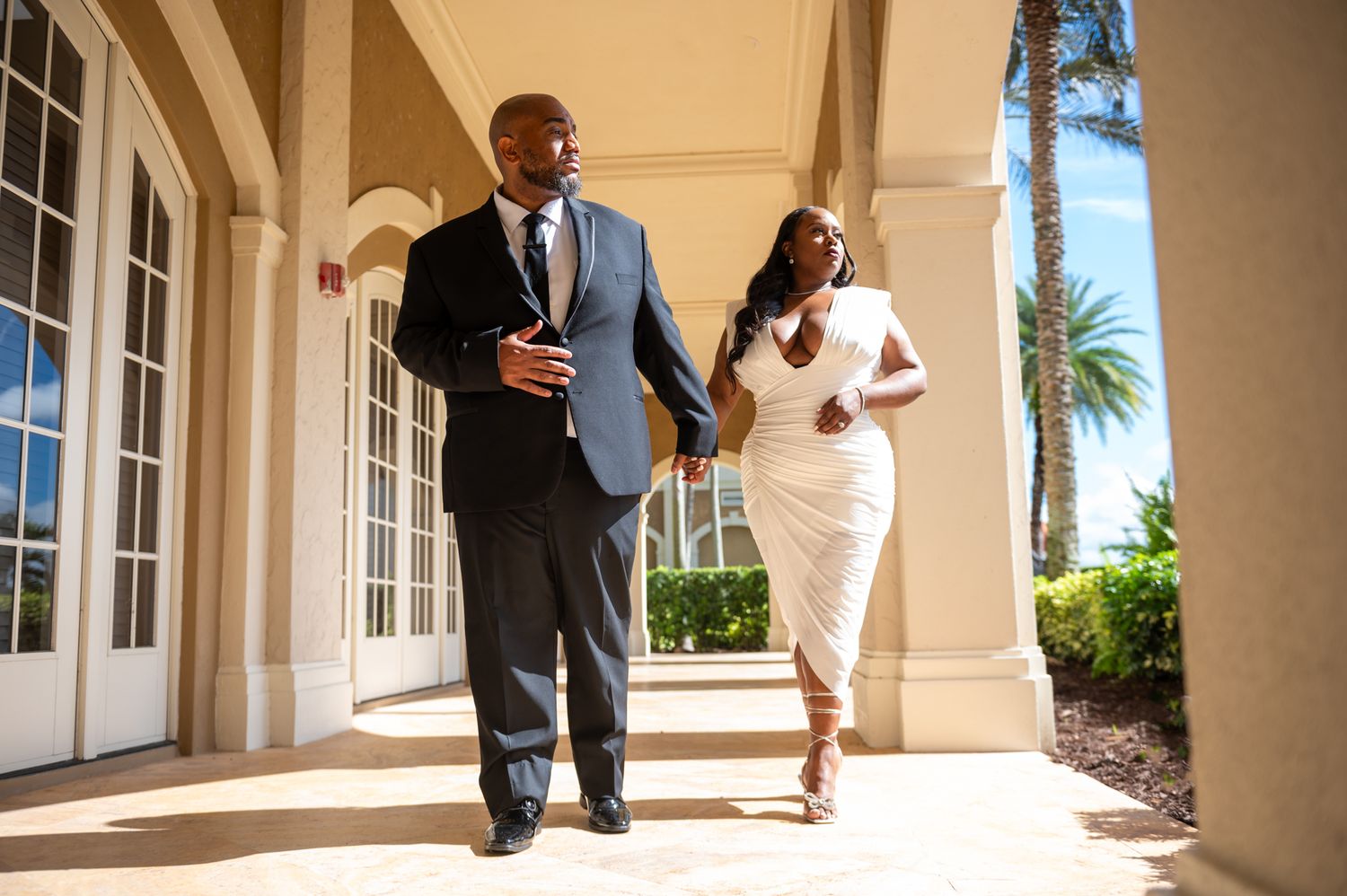 A couple walking hand-in-hand during an engagement session in Port St Lucie