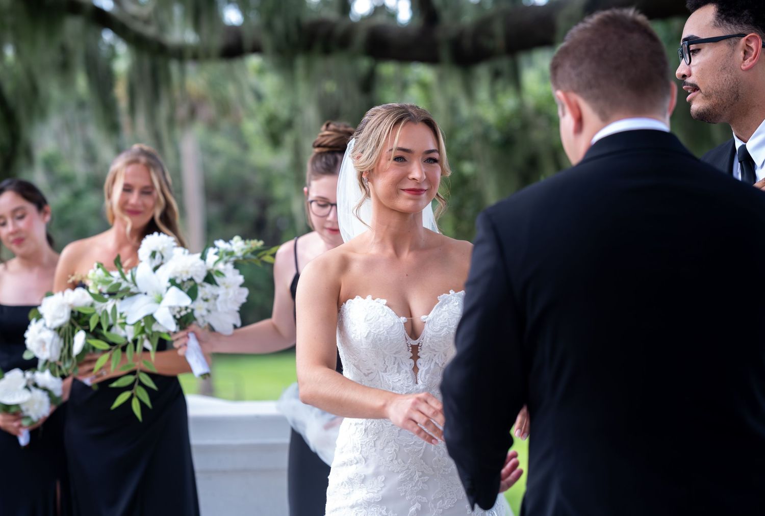 Groom laughing with groomsmen at lakeside terrace