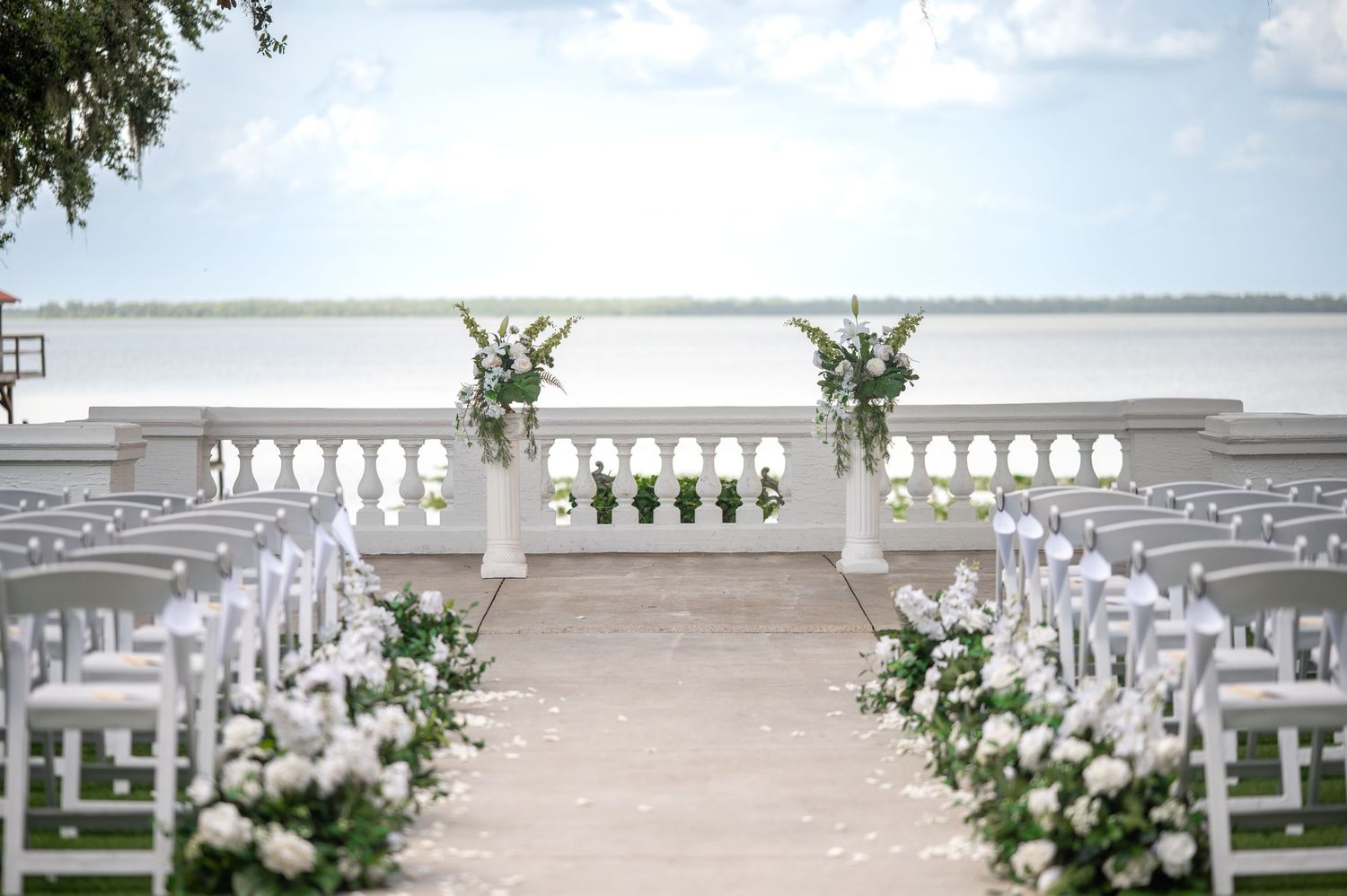 Bride’s veil and gown train trailing down marble staircase