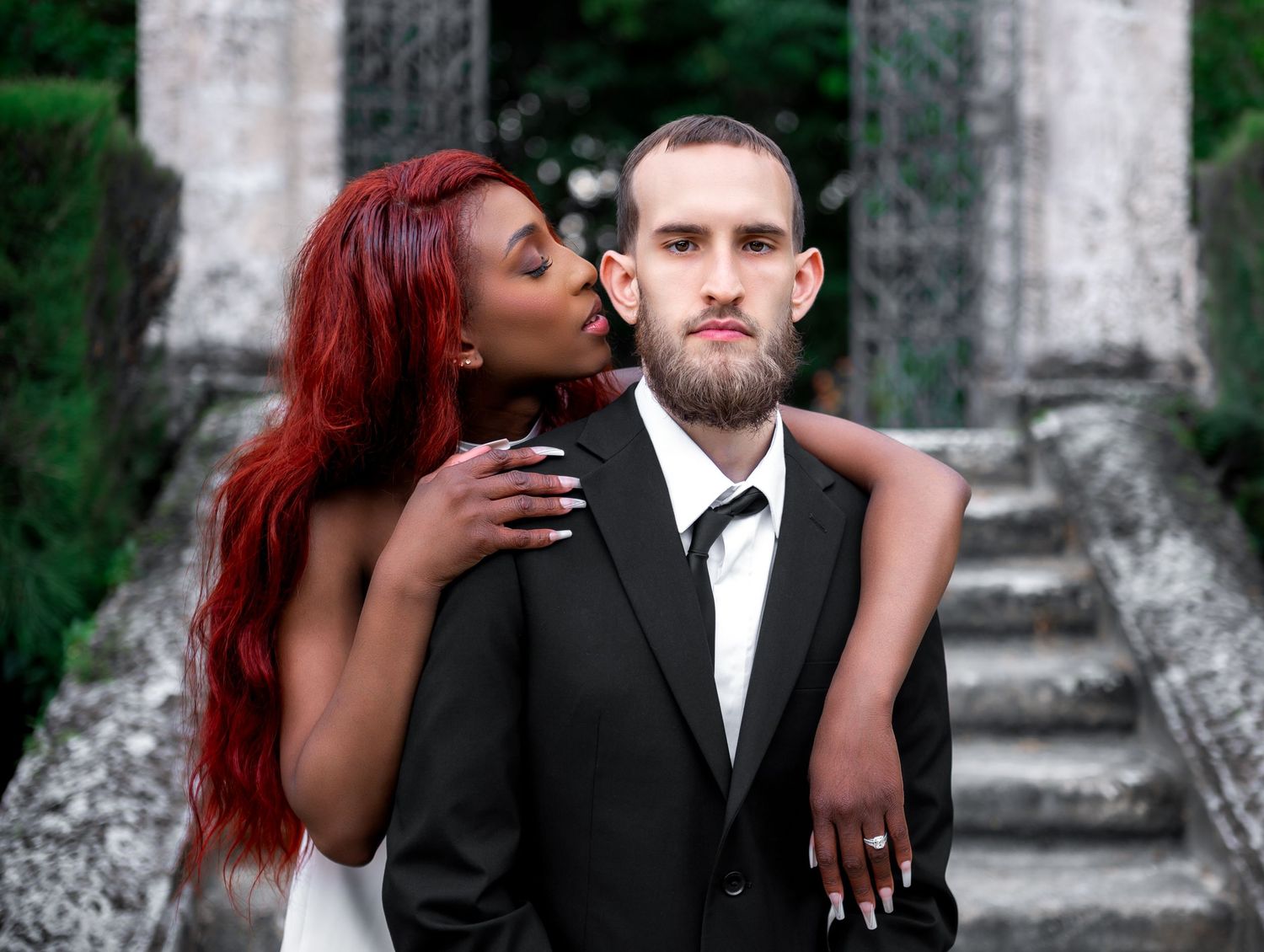 Elegant walking shot in Vizcaya’s garden path lined with urns, taken by Florida wedding photographers.