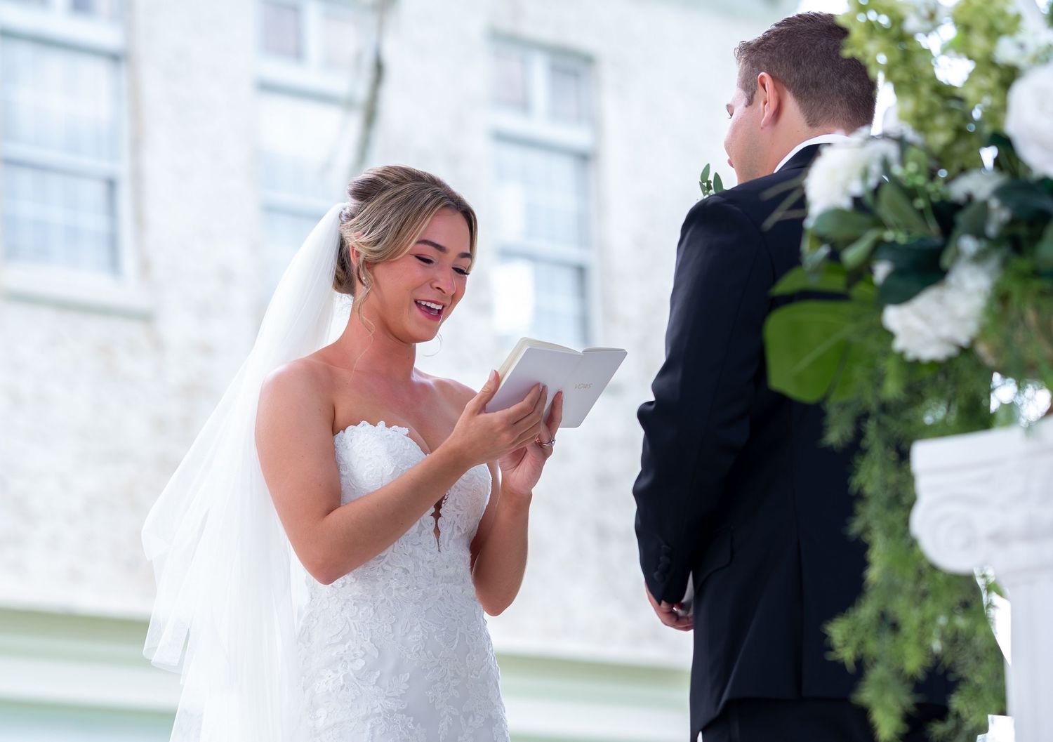 Florida wedding photographers captured this emotional reading of the vows moments after the couples first look at Bella Cosa wedding venue