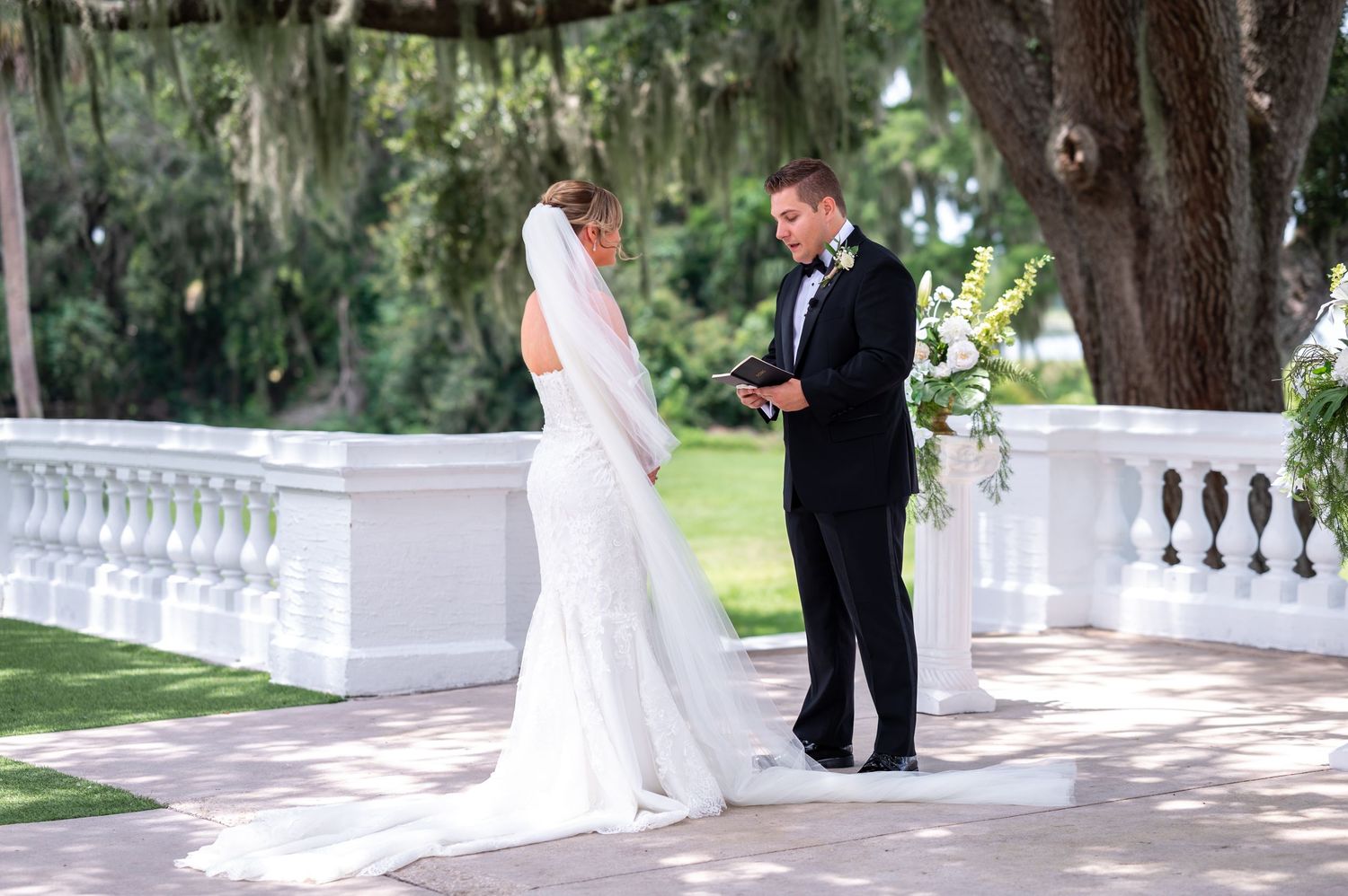Bride and groom with wedding party in Bella Cosa’s Mediterranean courtyard