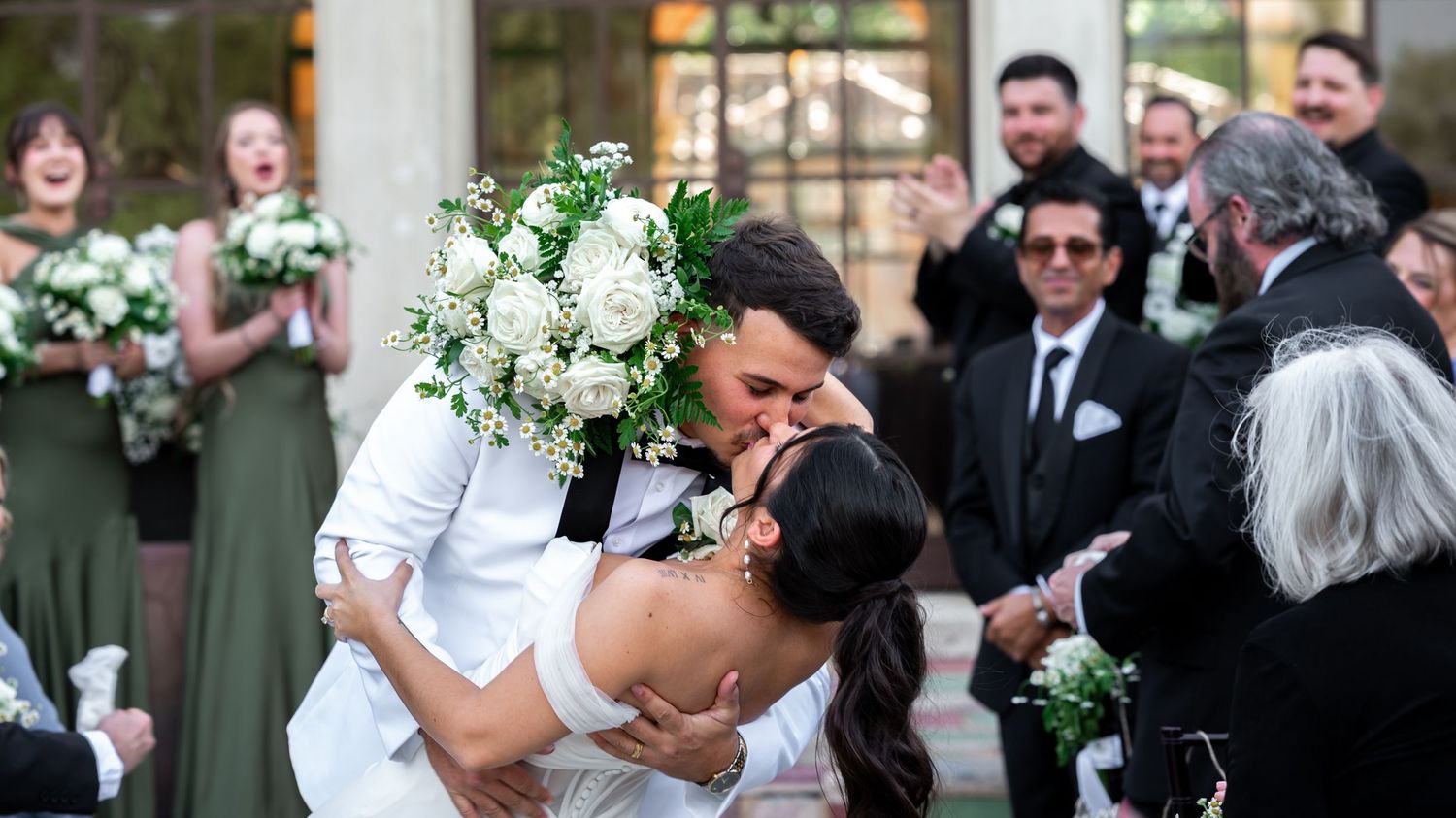 Groom tying his bowtie in natural light, photographed by South Florida wedding photographers.