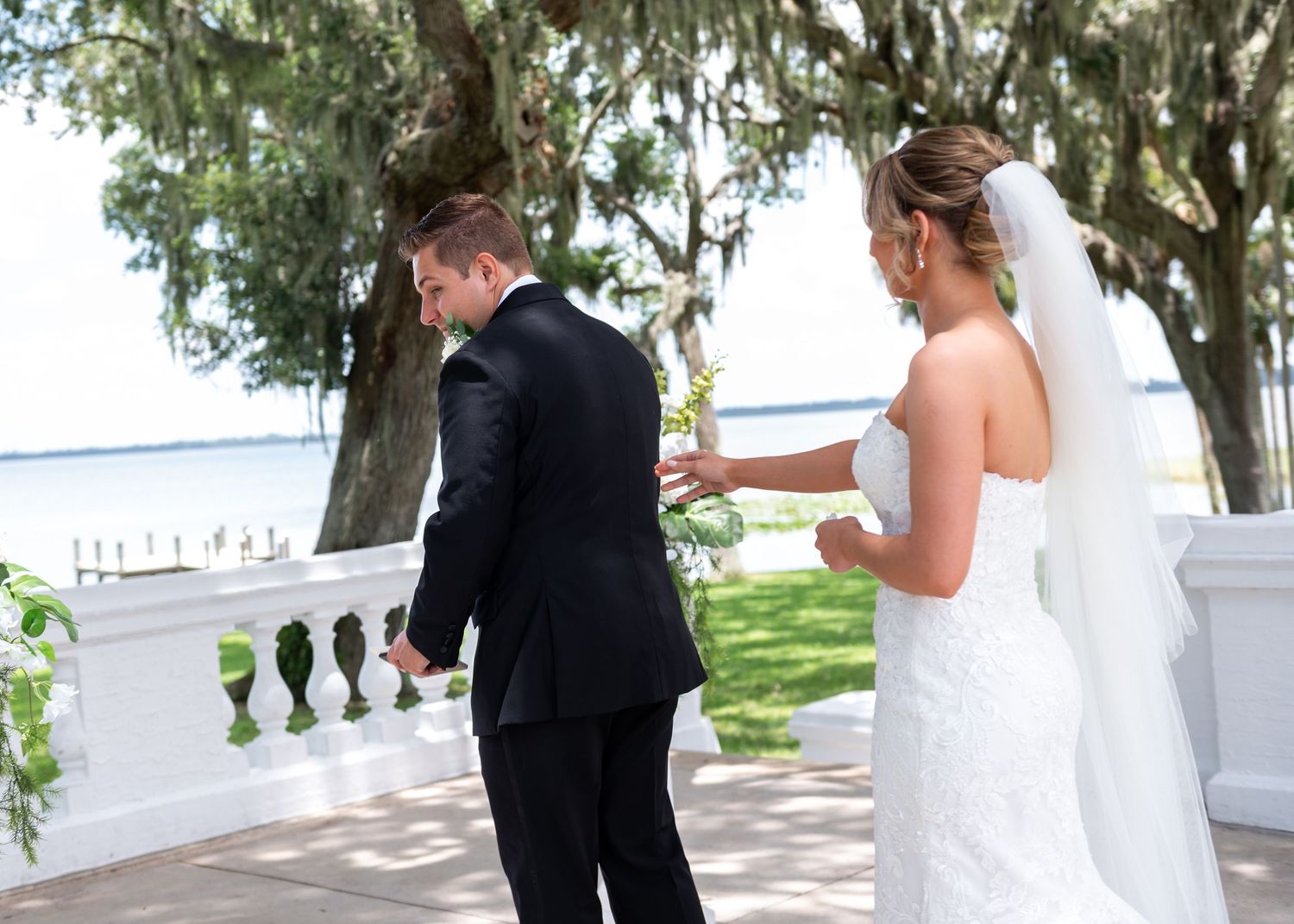 Groom straightening tie before ceremony at Bella Cosa wedding venue
