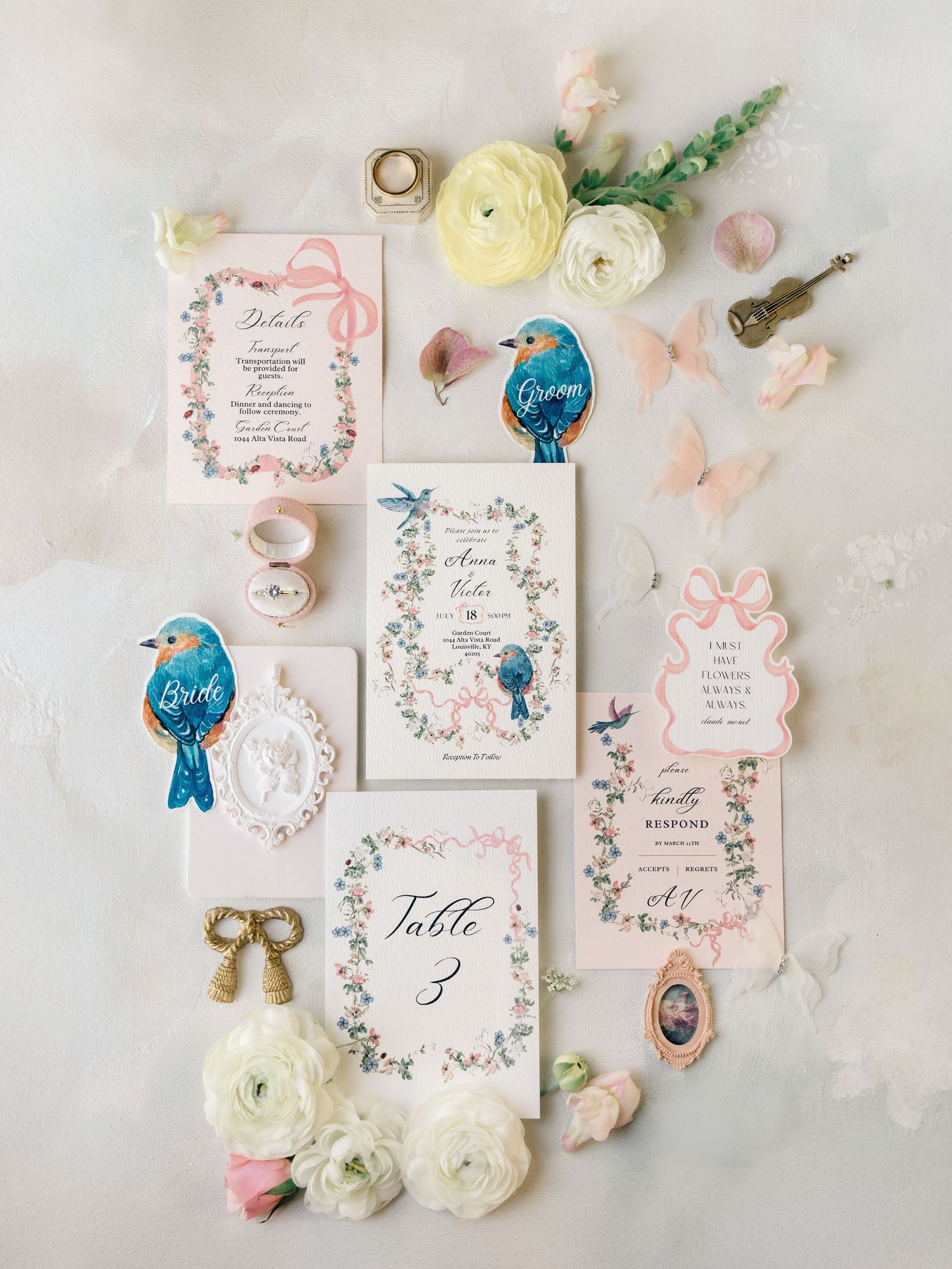Elegant wedding invitation suite with vintage keys, pink florals and delicate calligraphy on a light marble background.