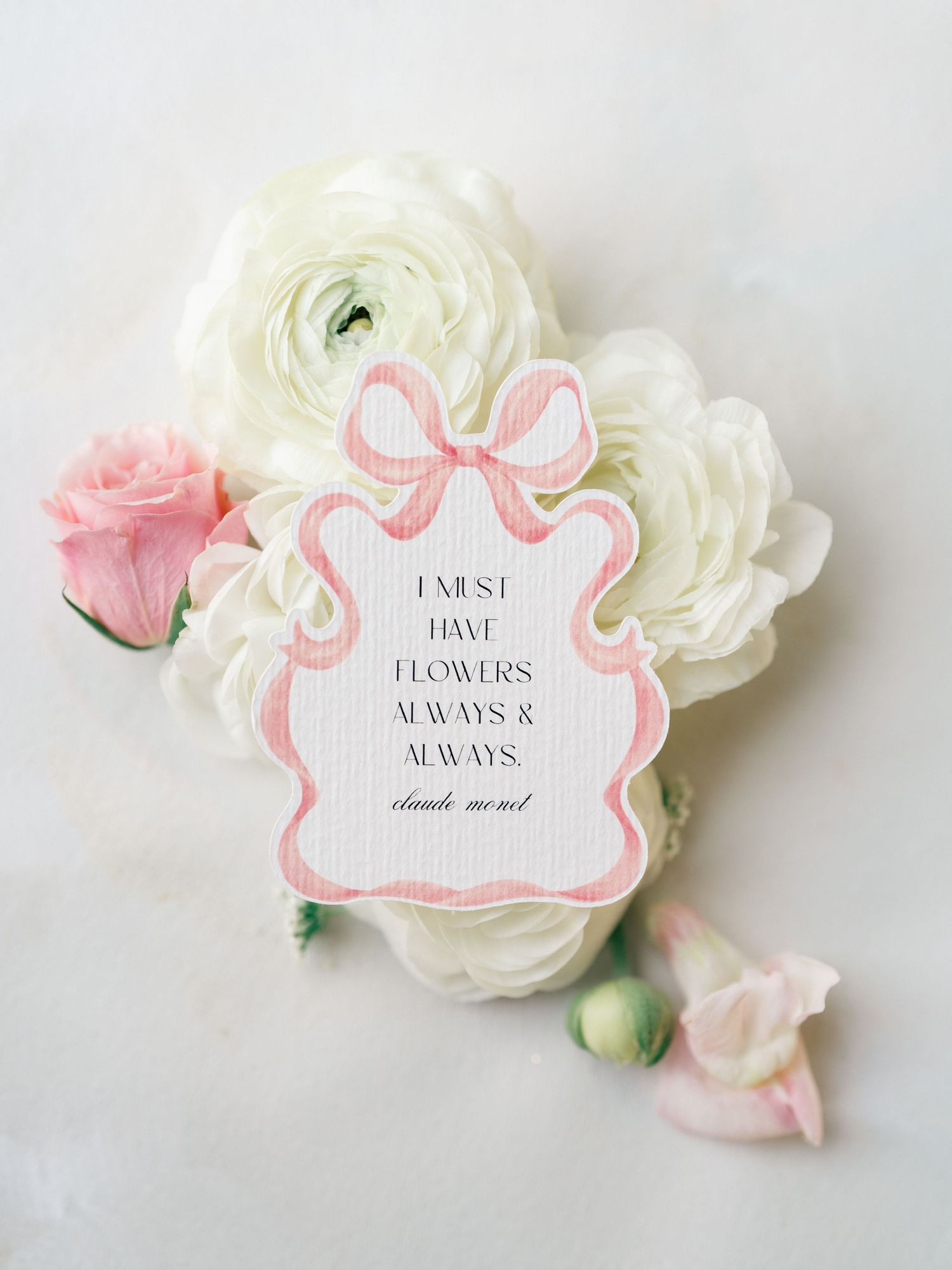 Elegant white and blush roses with pink accented gift tags displaying romantic text against a light backdrop.