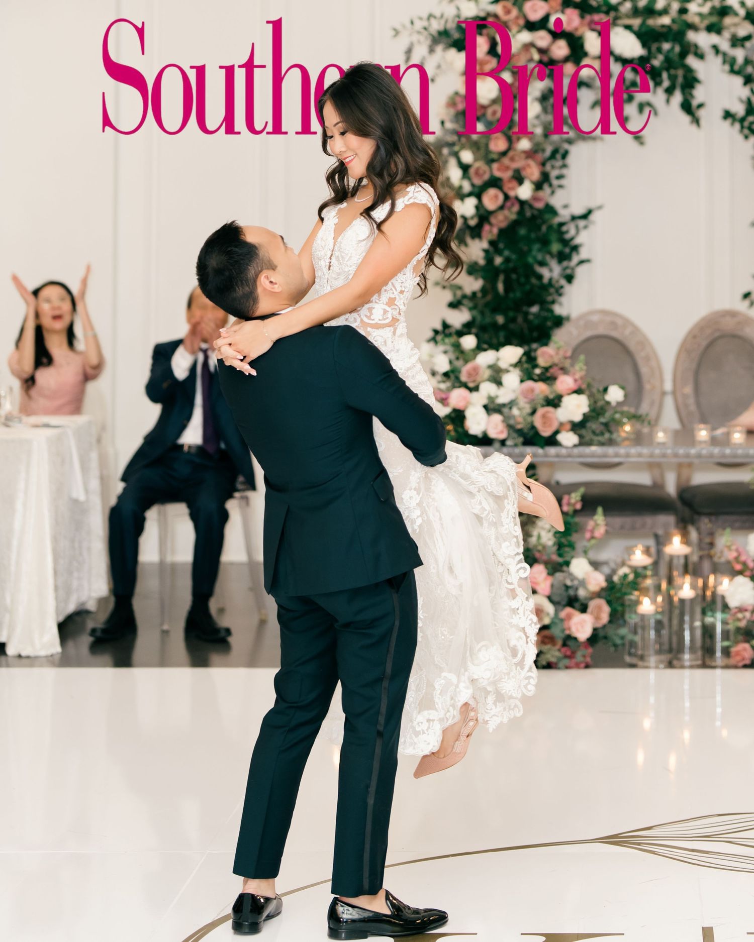 A romantic wedding dance moment captured at an elegant venue with white floral decorations and pink magazine title overlay.
