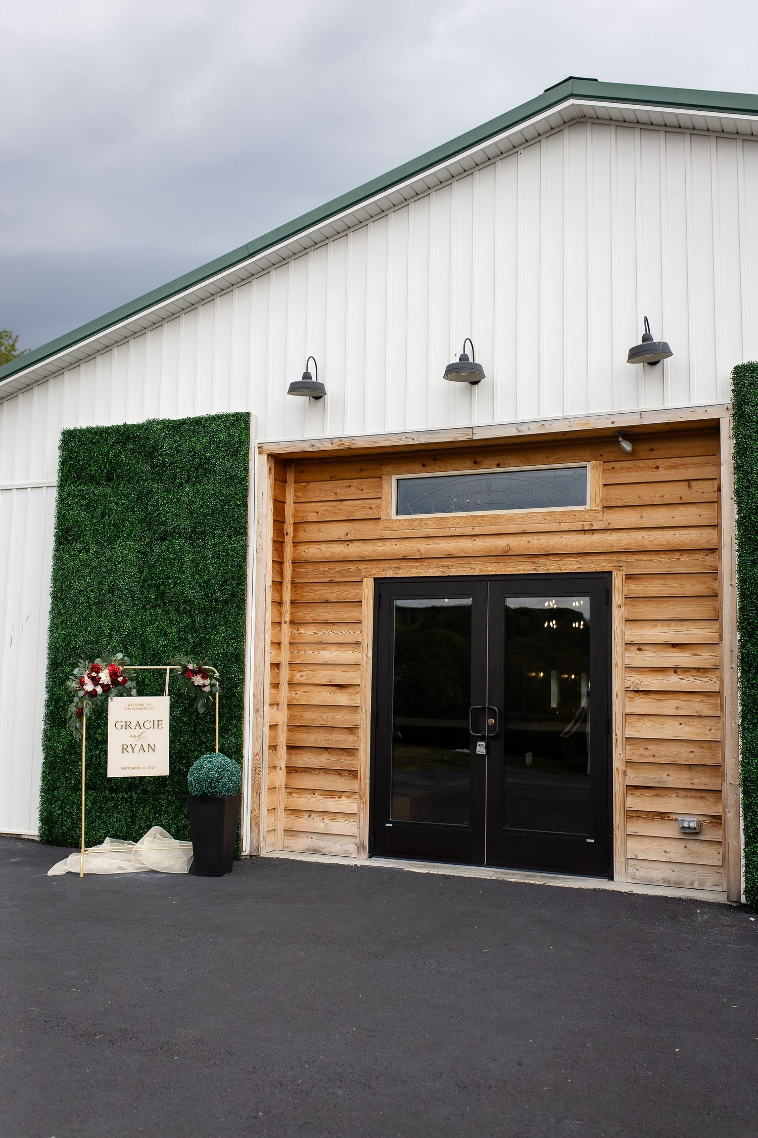 Outside view of The Monarch Veil reception hall with wood and white siding.
