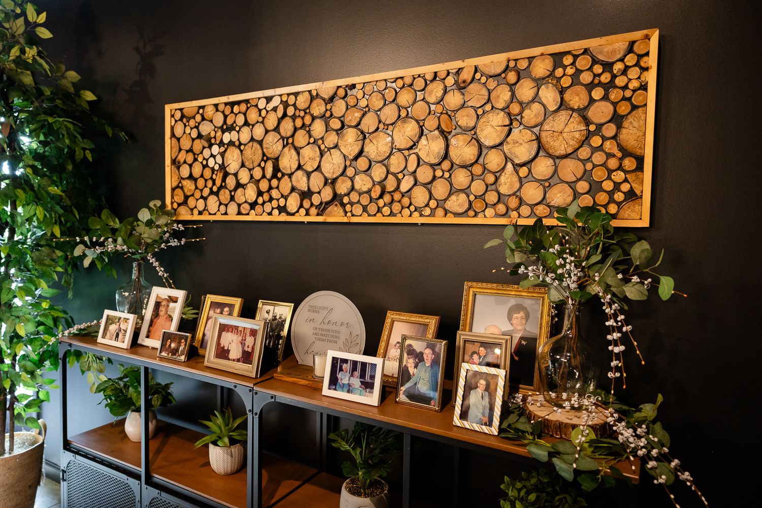 view of a memory table at a wedding reception under a wood log artwork piece