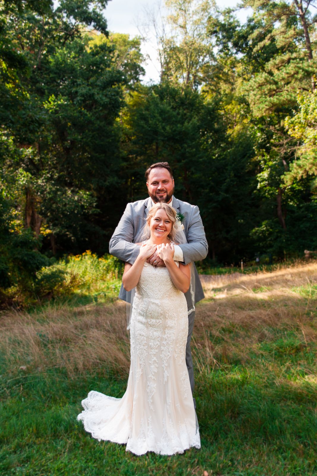 tall man with his arms around his wife
