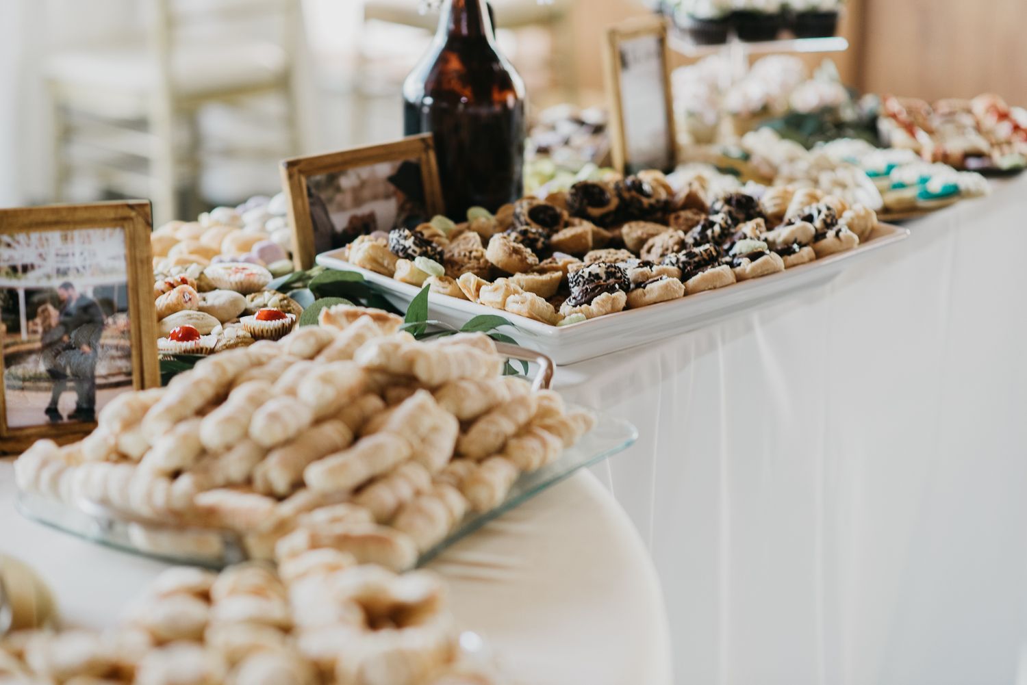 cookies on trays amidst photo frames and beer growlers