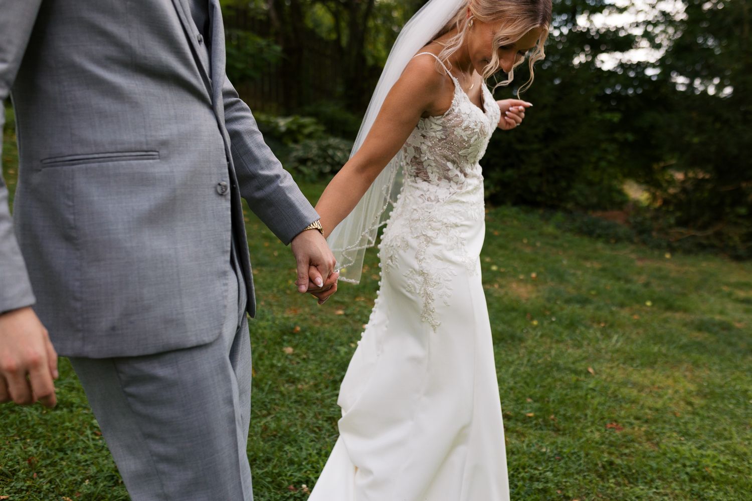 man and woman holding hands while walking