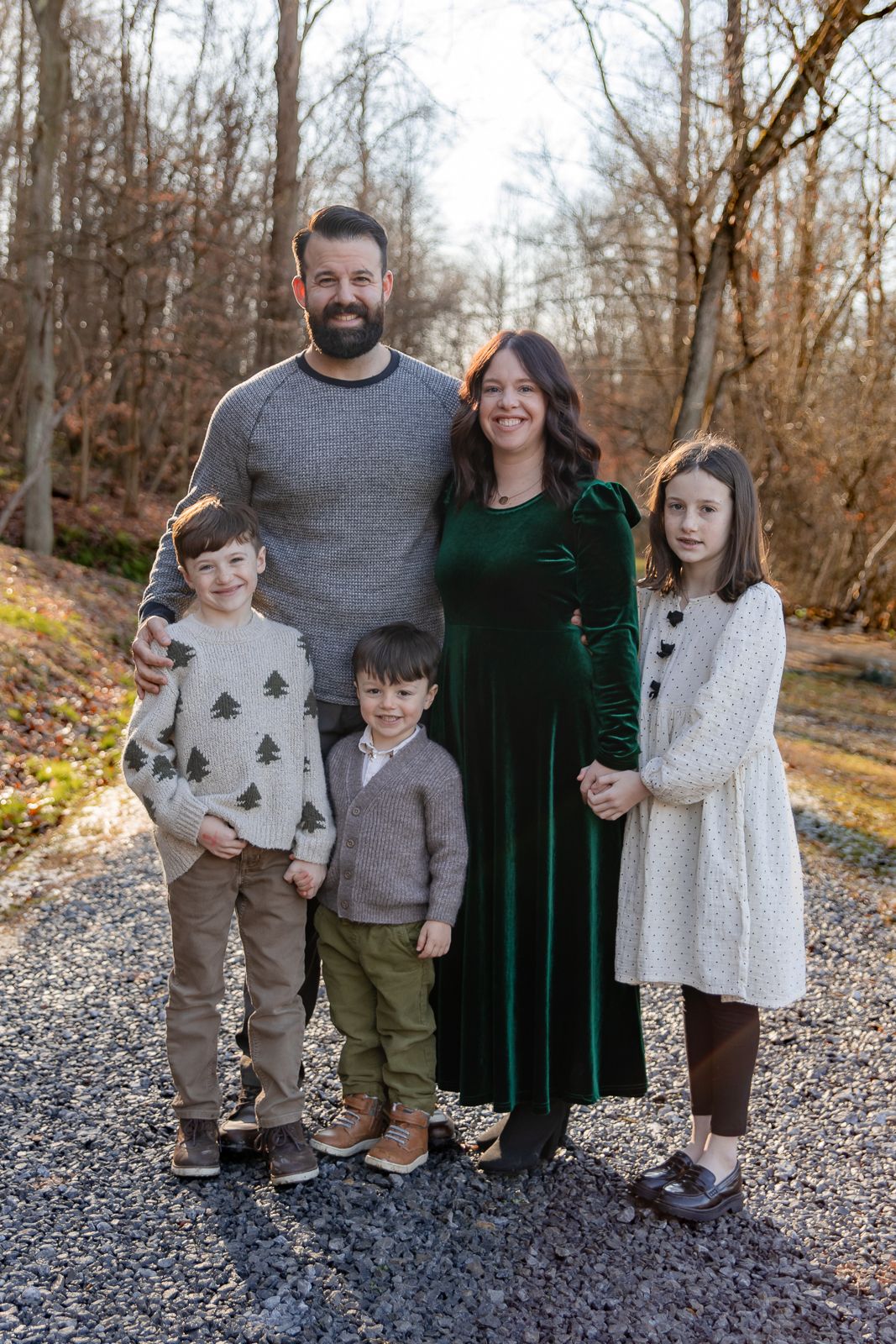 family of five in stylish fall outfits posing for the camera