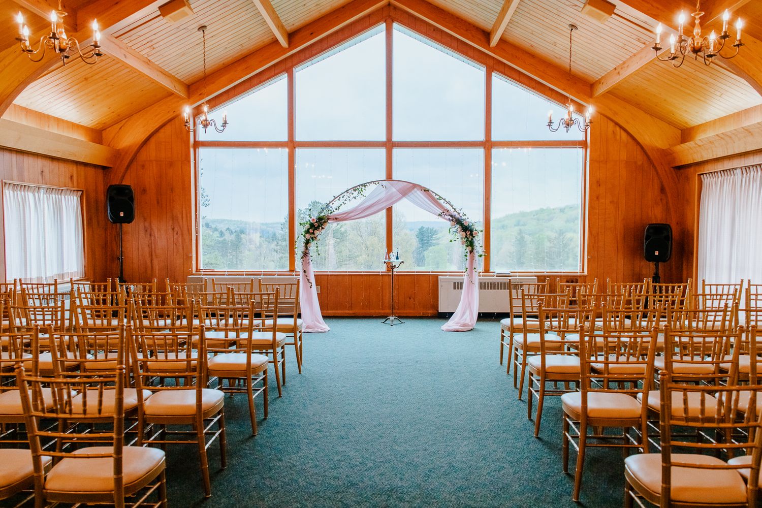 indoor wedding ceremony location at Kittanning Country Club featuring floor to ceiling windows