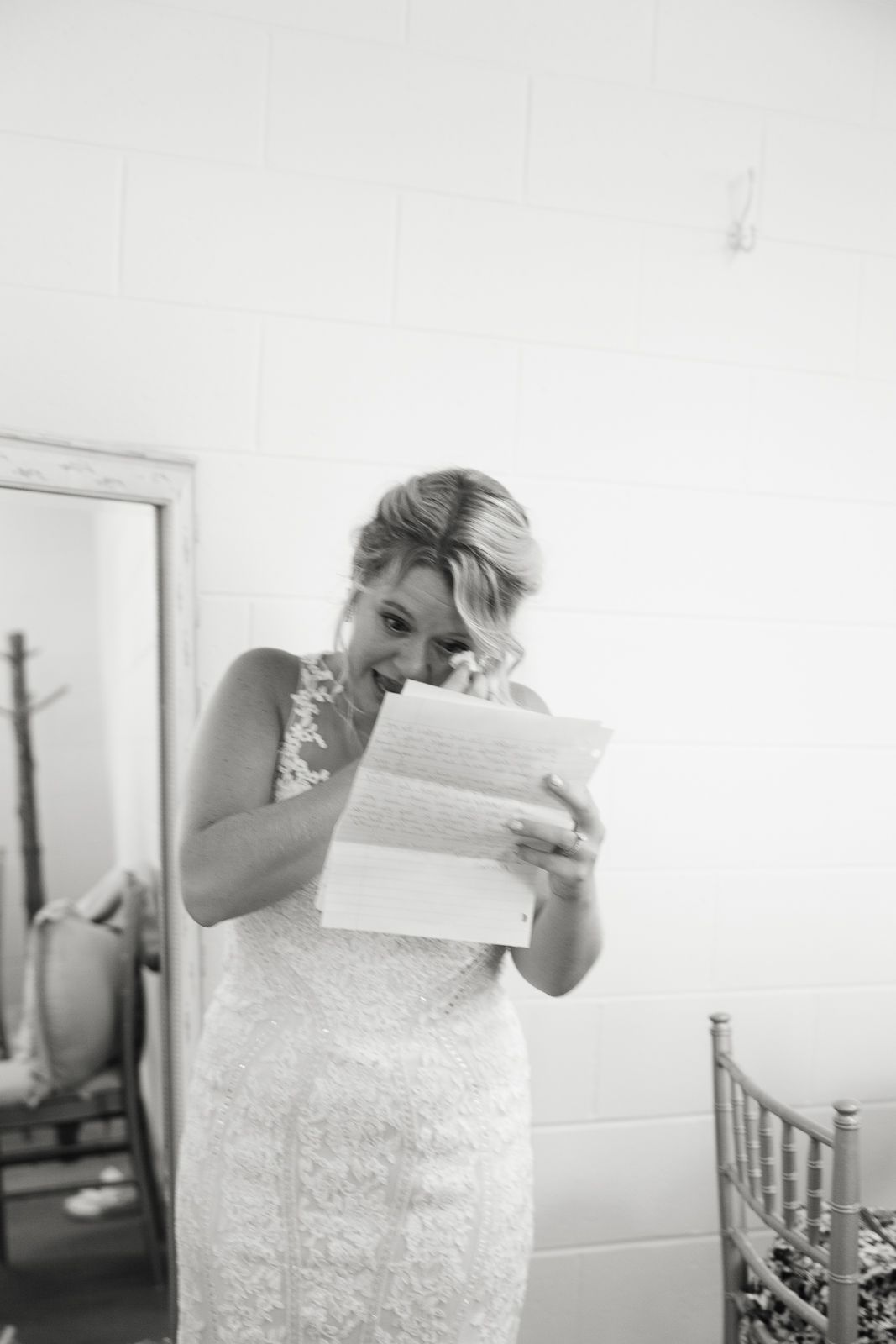 bride tearing up while reading letter written by her soon to be husband