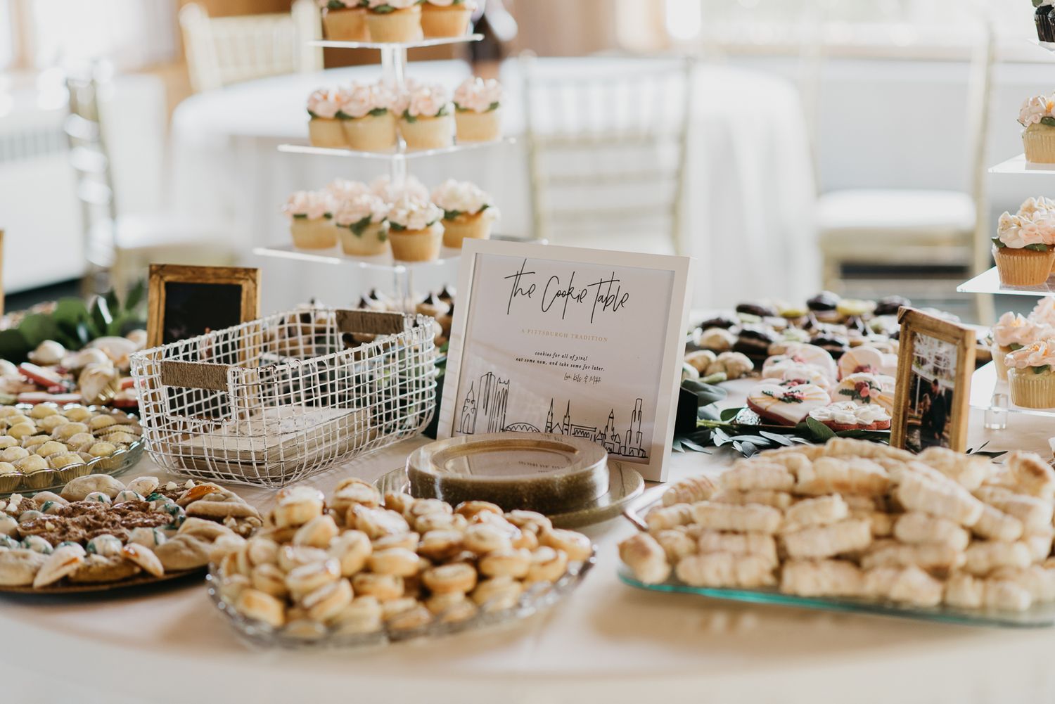 framed writing sitting on table surrounded by cookies for the traditional Pittsburgh wedding cookie table