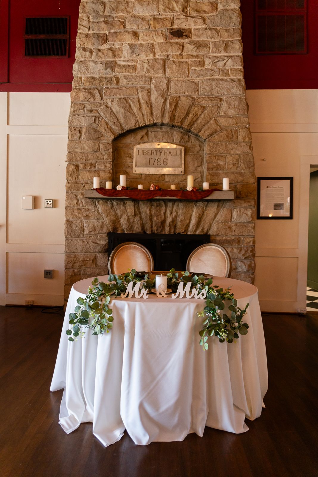 sweetheart wedding table in front of stone fireplace