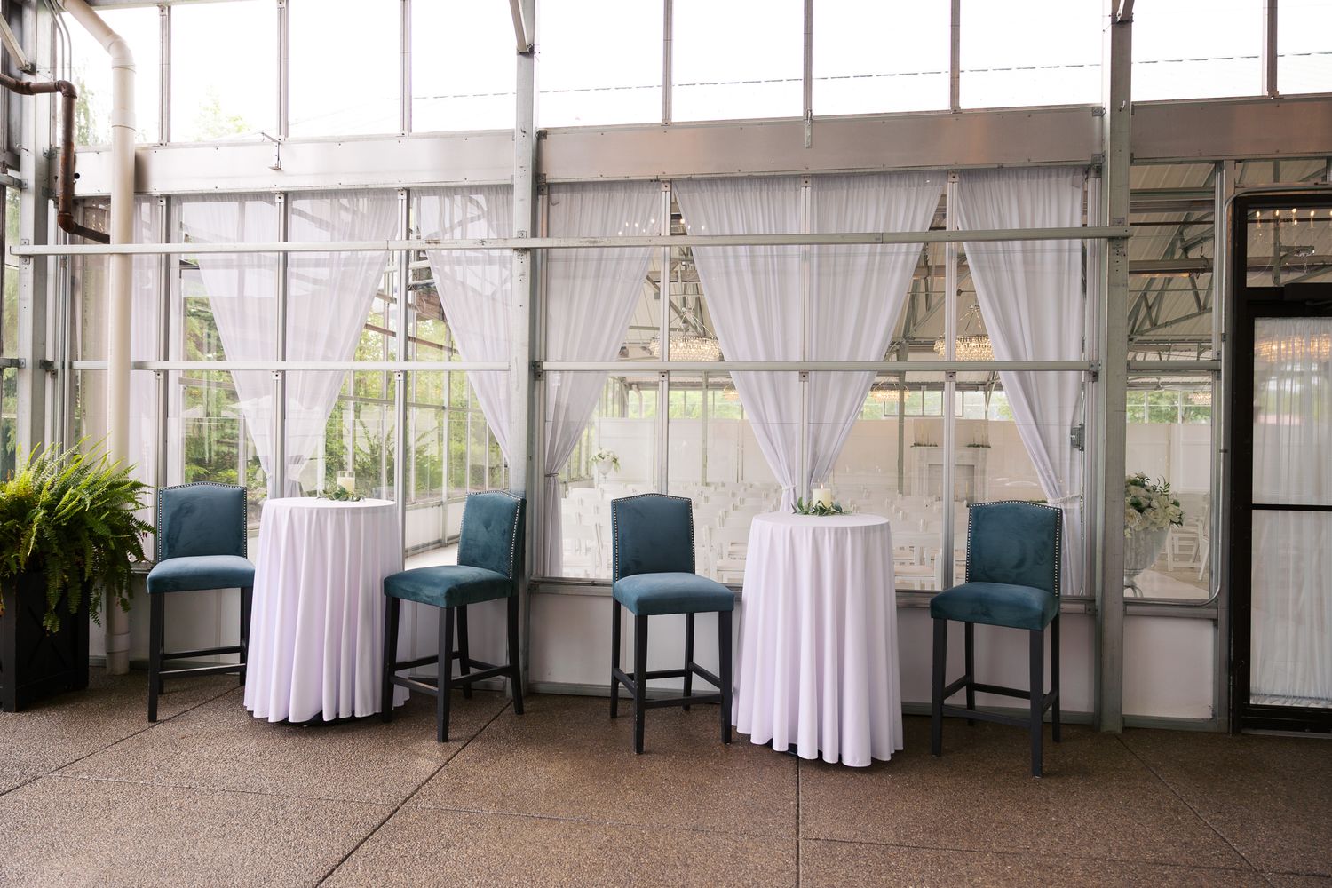 cocktail tables and chairs set up at The Atrium all season wedding venue in Butler PA