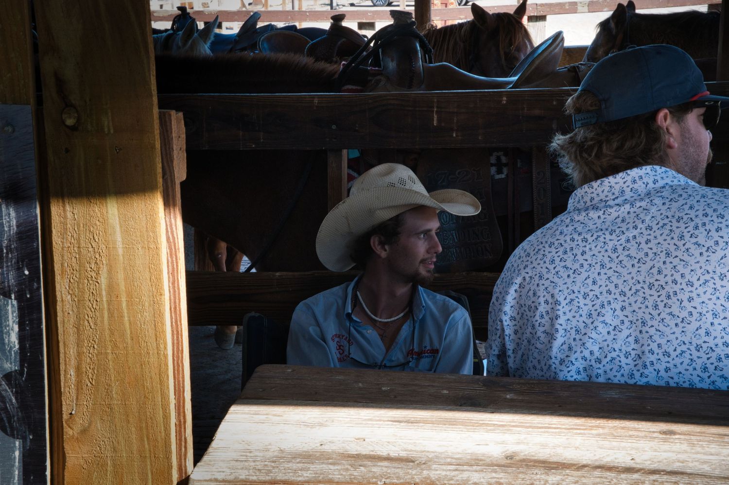 Interior view of a rustic western-style establishment with patrons seated at bar.