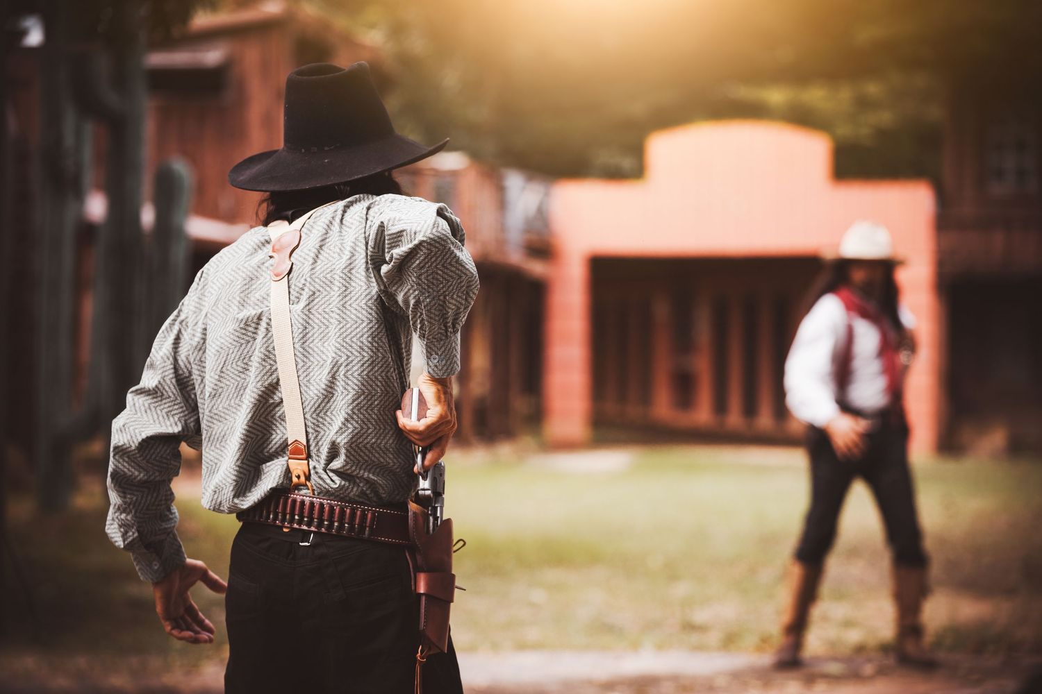 A western scene with silhouetted cowboys in a dusty sunset atmosphere.