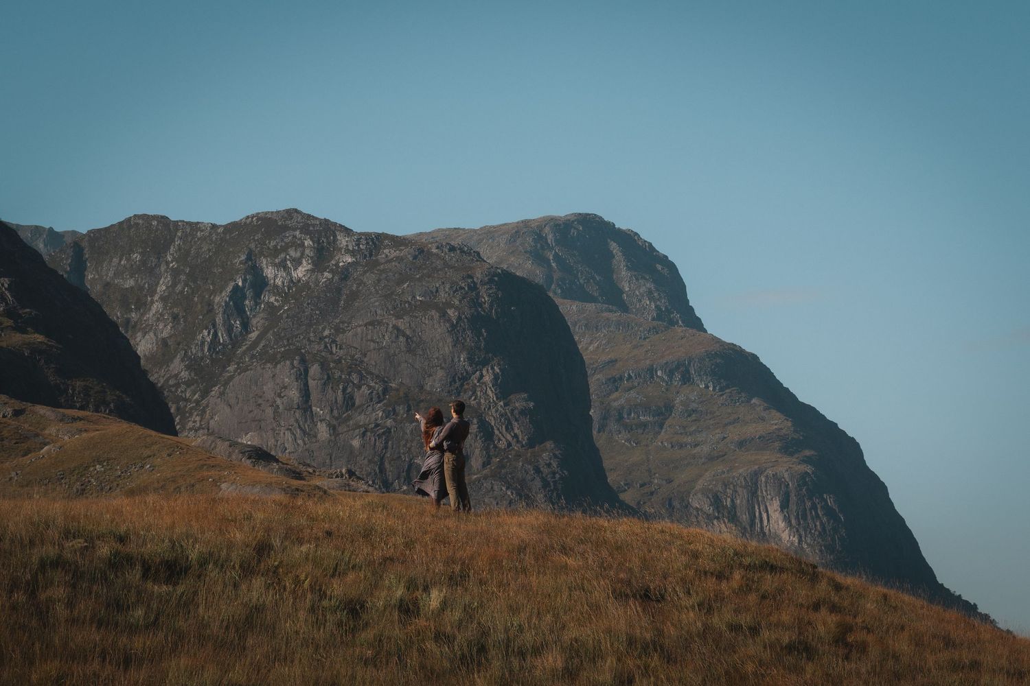Asenata and Peter walking through a valley in Glencoe, Scotland