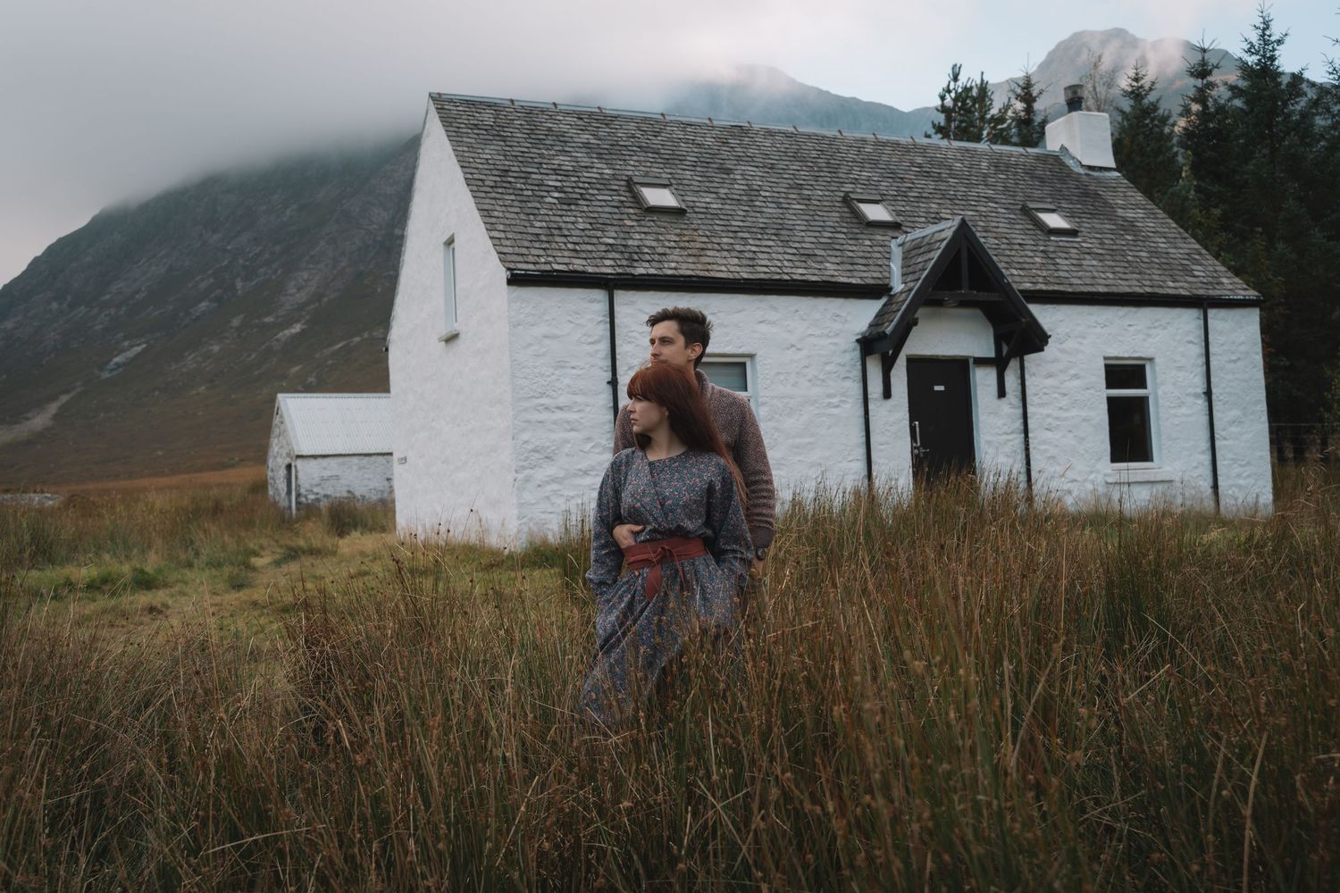 Asenata and Peter walking through a valley in Glencoe, Scotland
