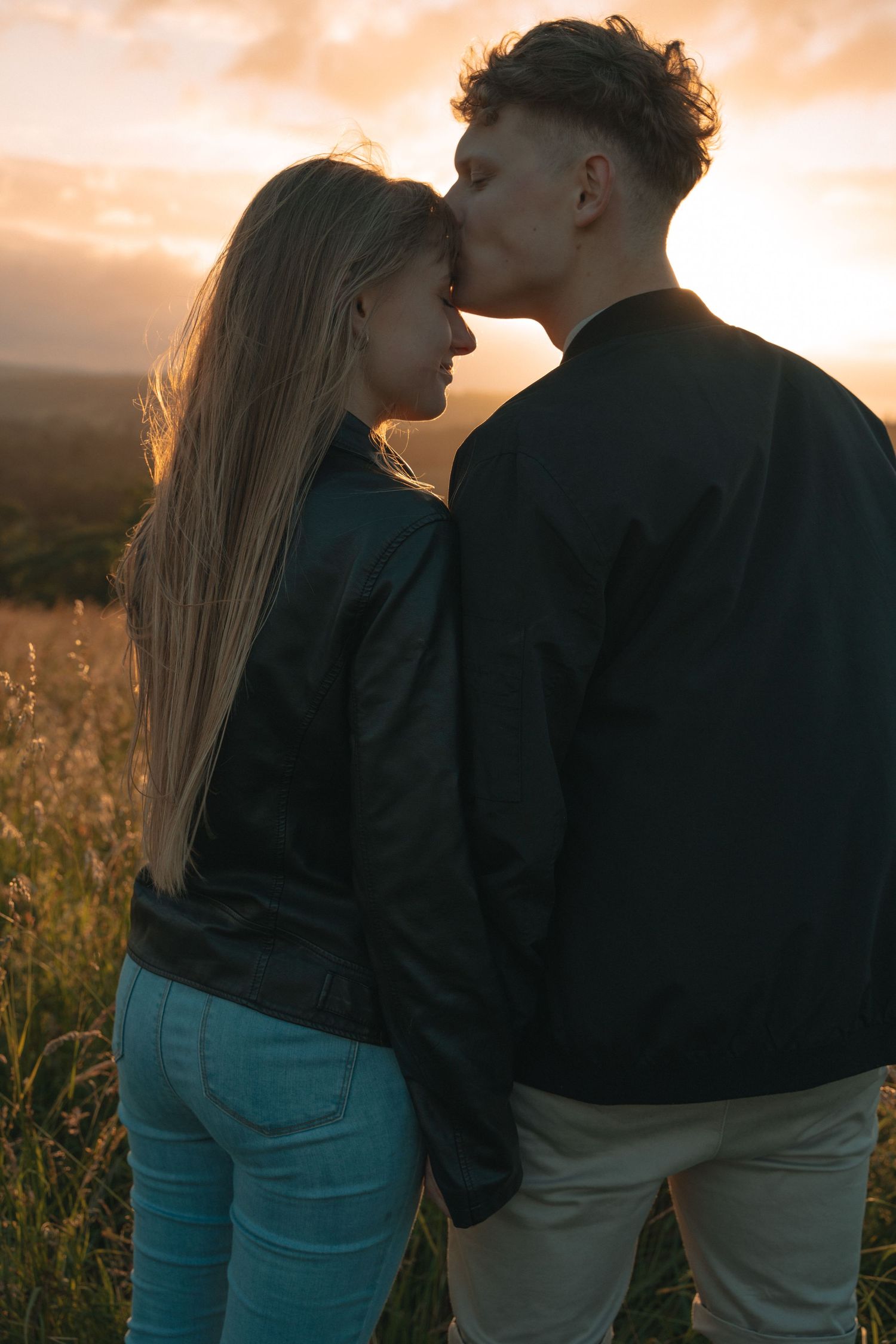 Couple walking through the Scottish Highlands during golden hour