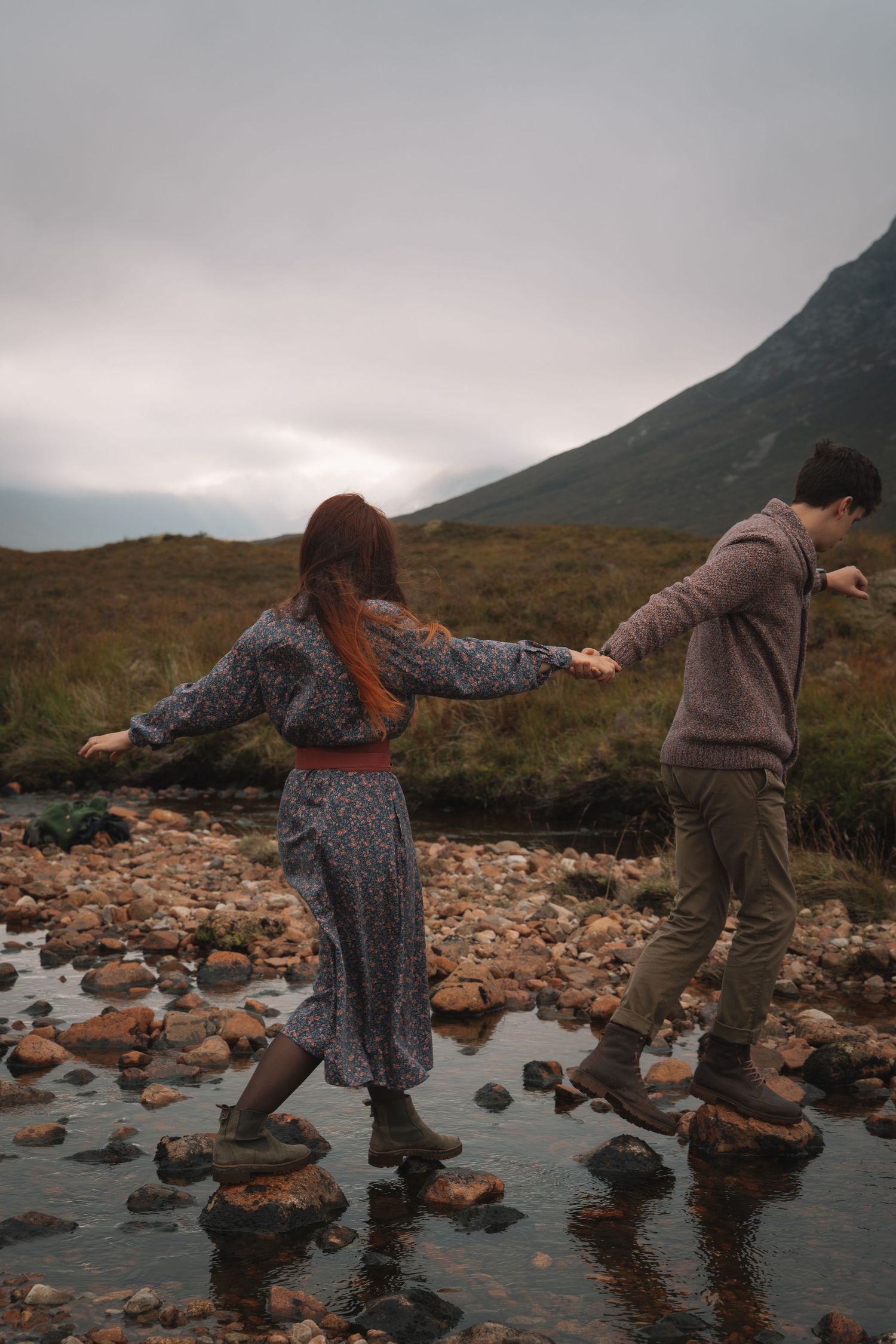 Laughing couple spinning during engagement-style session